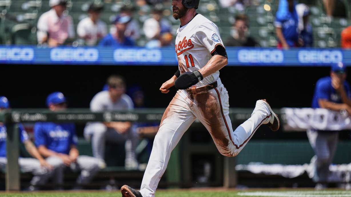 Baltimore Orioles' Jordan Westburg (11) advances toward home plate to score on a sacrifice fly hit by Tyler O'Neill during the first inning in the first baseball game of a doubleheader against the Toronto Blue Jays, Tuesday, July 29, 2025, in Baltimore.