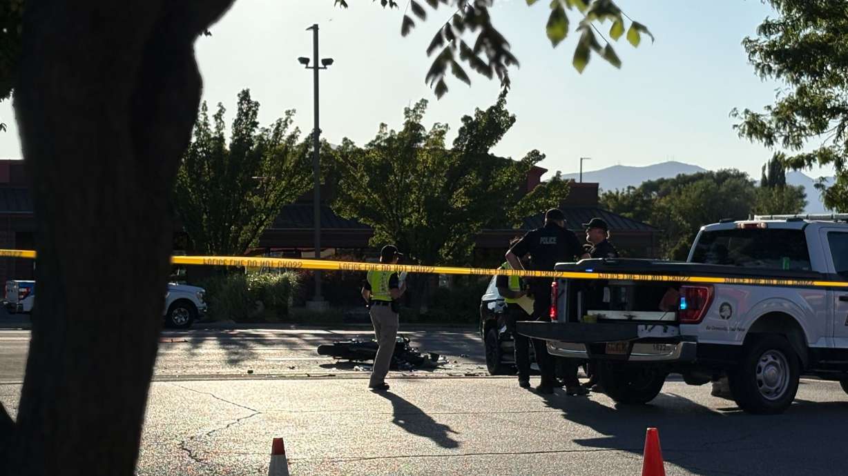 Police investigate a crash scene at 10363 S. Redwood Road in South Jordan, where a 31-year-old motorcyclist was killed when he collided with an SUV on Tuesday.