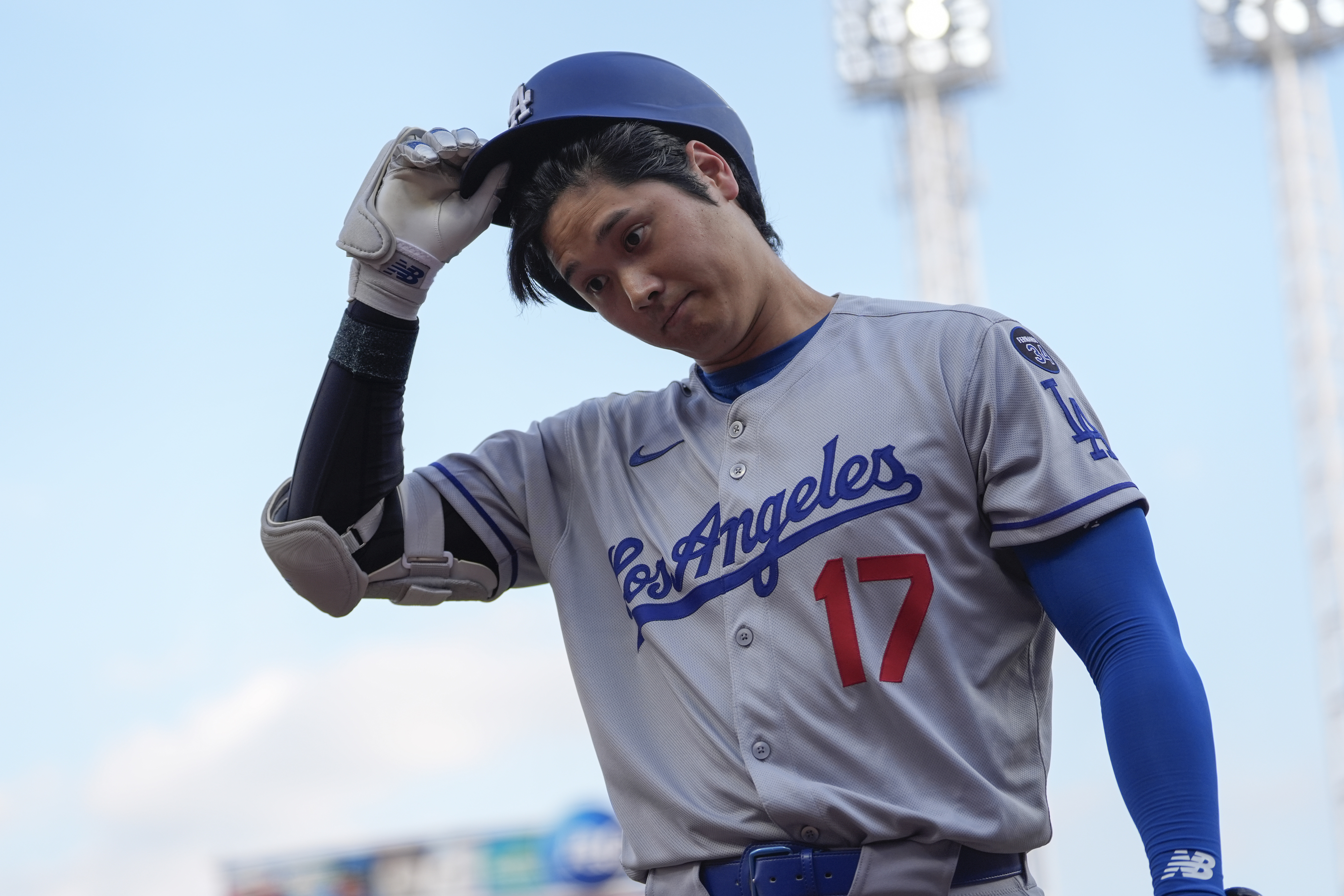 Los Angeles Dodgers' Shohei Ohtani walks to the dugout after striking out during the first inning of a baseball game against the Cincinnati Reds, Tuesday, July 29, 2025, in Cincinnati. 