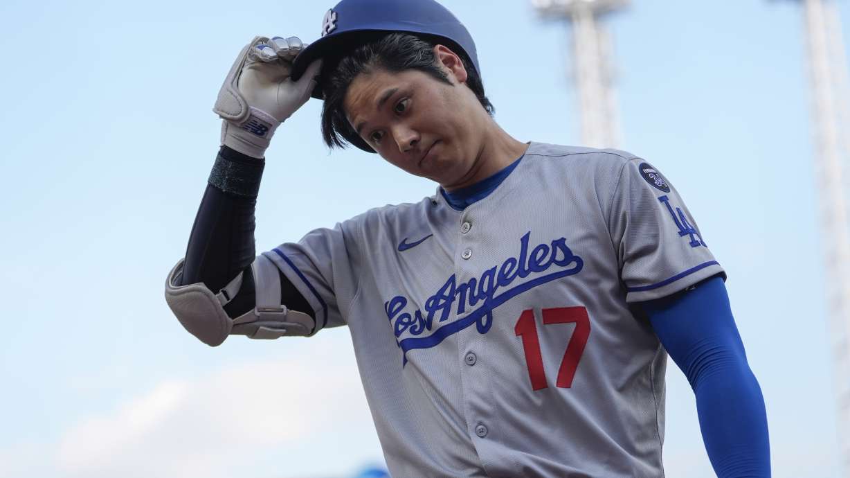 Los Angeles Dodgers' Shohei Ohtani walks to the dugout after striking out during the first inning of a baseball game against the Cincinnati Reds, Tuesday, July 29, 2025, in Cincinnati.