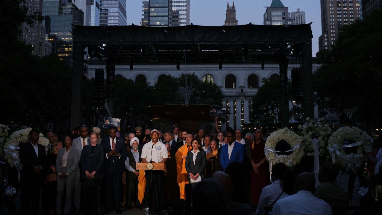 New York Mayor Eric Adams speaks during a vigil for the people killed by a gunman at a Manhattan office building a day prior, Tuesday, at Bryant Park in New York.