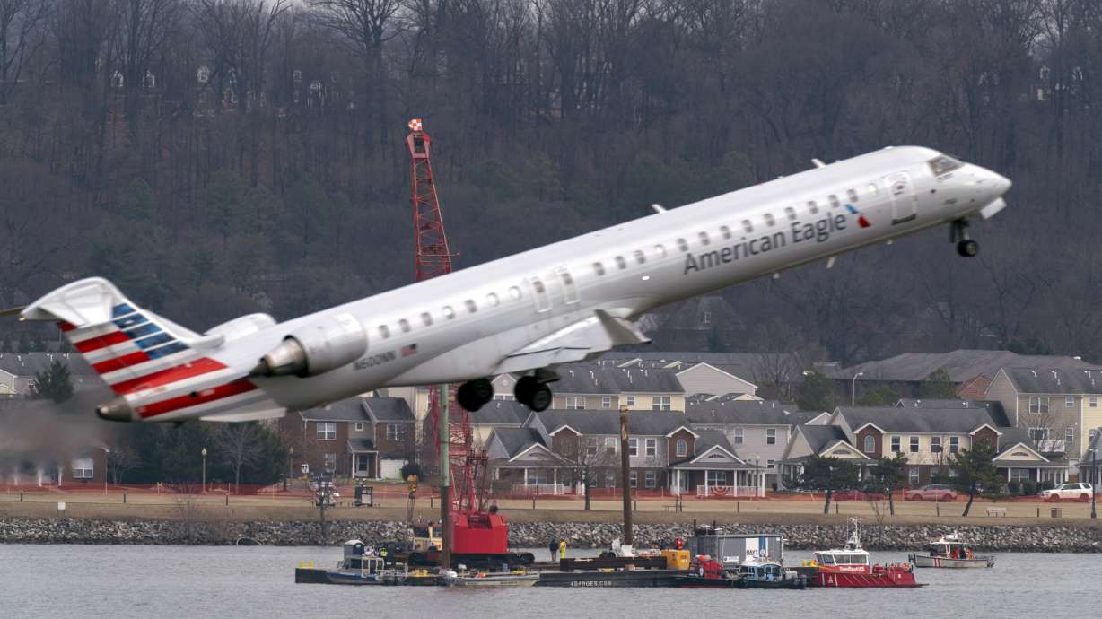 Salvage crews work on recovering wreckage near the site in the Potomac River of a mid-air collision between an American Airlines jet and a Black Hawk helicopter at Ronald Reagan Washington National Airport, Feb. 6, in Arlington, Va. Wednesday, investigators said the helicopter was flying above its altitude limit.