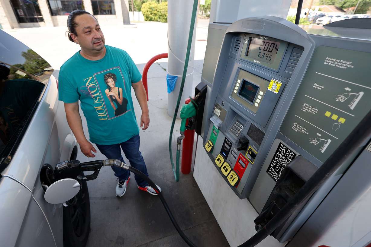 Eric Gonzales fuels up at Shoppers Express in Salt Lake City on June 27. The EPA is proposing to roll back tailpipe emissions standards that date back to 2009.
