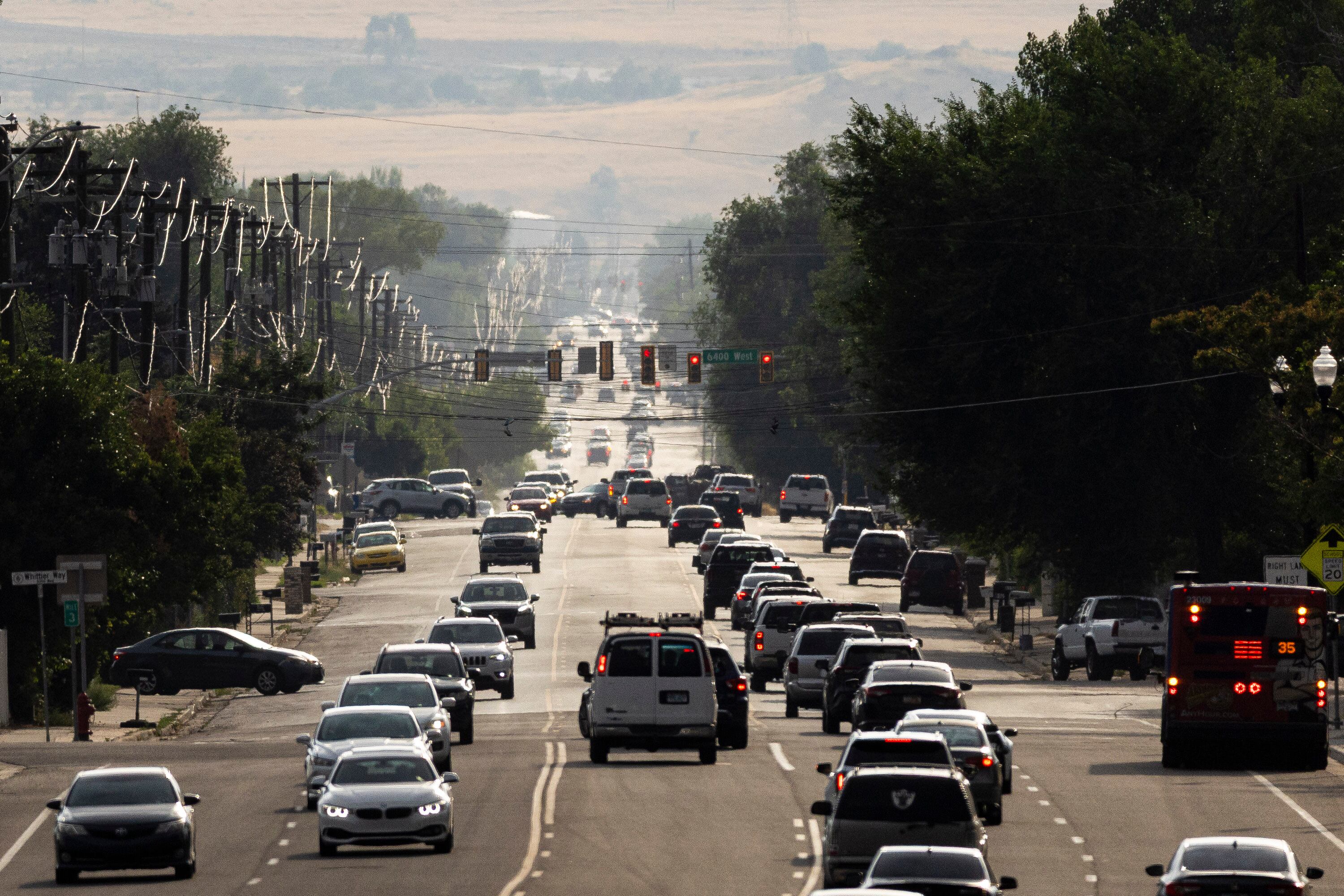 Traffic flows along 3500 South in West Valley City on July 15. Christy Goldfuss, executive director of the Natural Resources Defense Council, said the EPA's proposed rollback of tailpipe emission standards will worsen climate impacts and endanger human health and welfare.