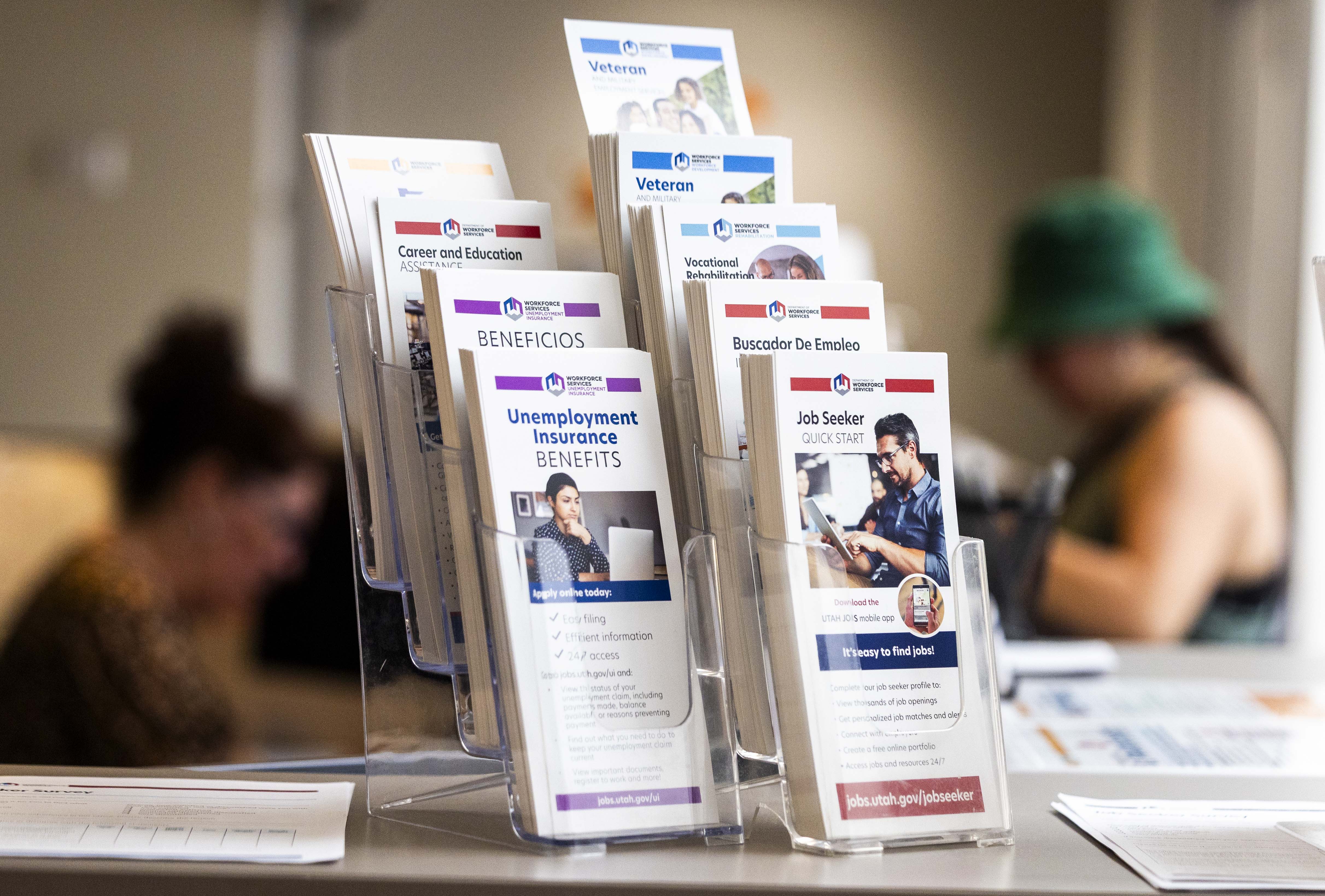 Pamphlets are pictured while a person talks with a worker at the Utah Department of Workforce Services in Taylorsville on July 3.
