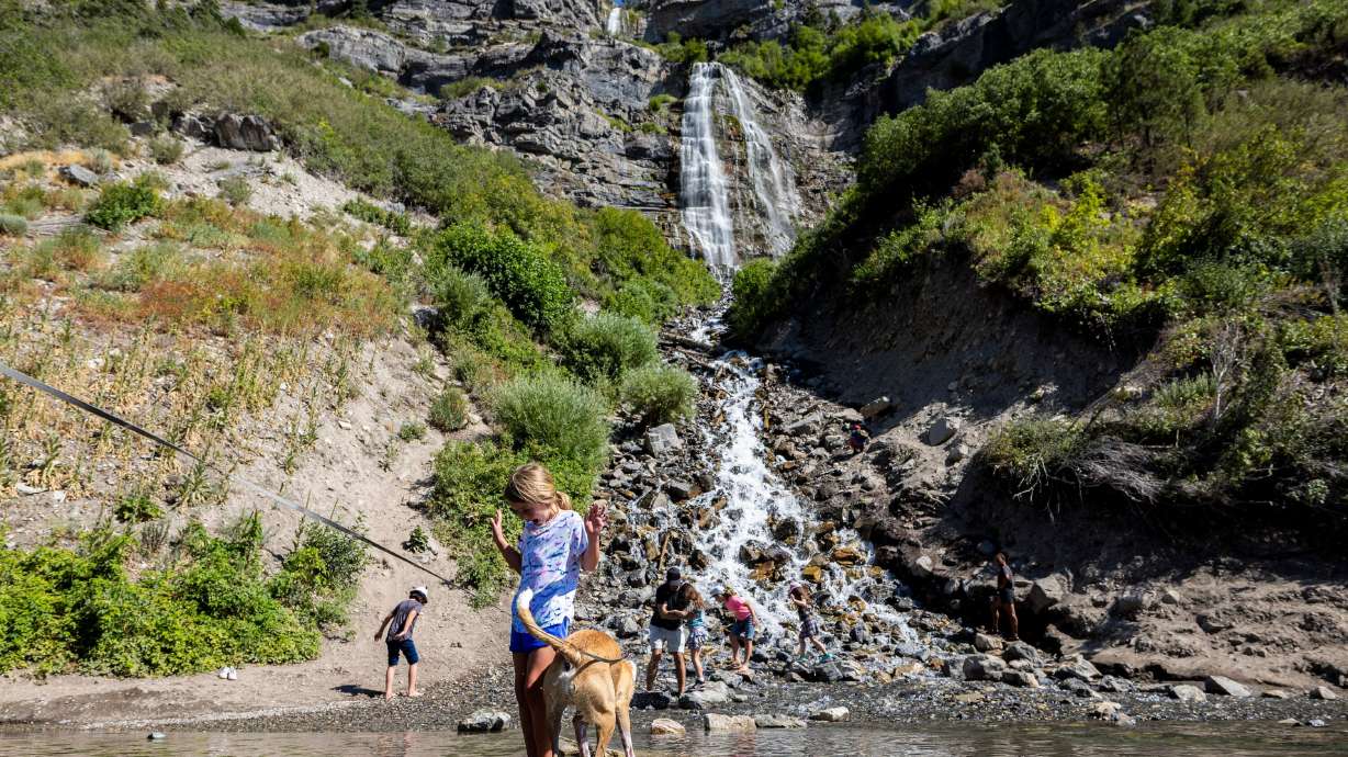 Roselyn Grill, 6, of Orem, stands on a rock with her mother’s dog as they play at the base of Bridal Veil Falls in Provo Canyon on July 19. Utah County leaders say a two-year project to enhance the experience in the area will begin after Labor Day.