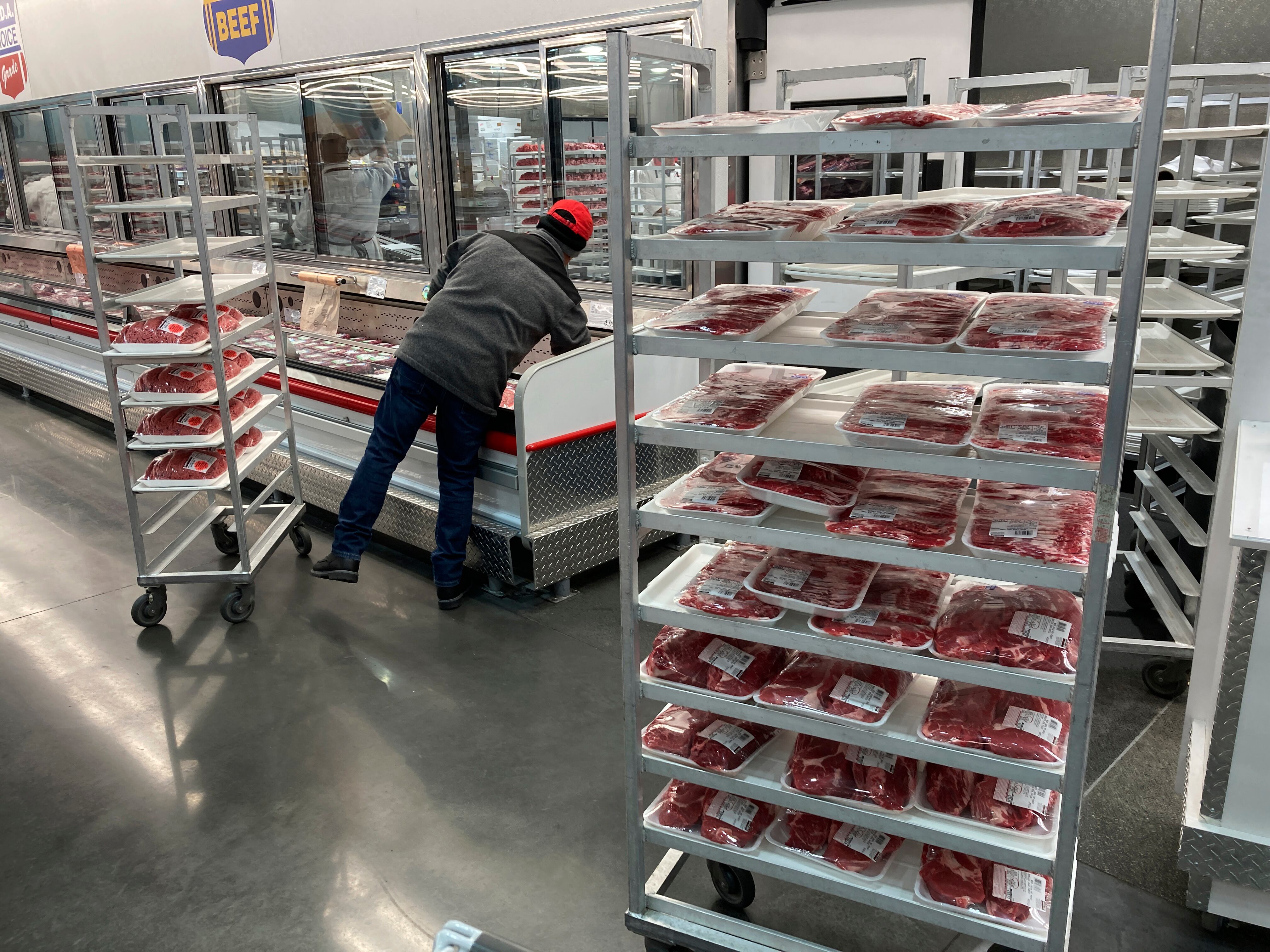 An employee restocks meats at a grocery store on Jan. 17, 2023, in North Miami, Fla. The FDA advises proper hygiene and food handling techniques to prevent foodborne illnesses.