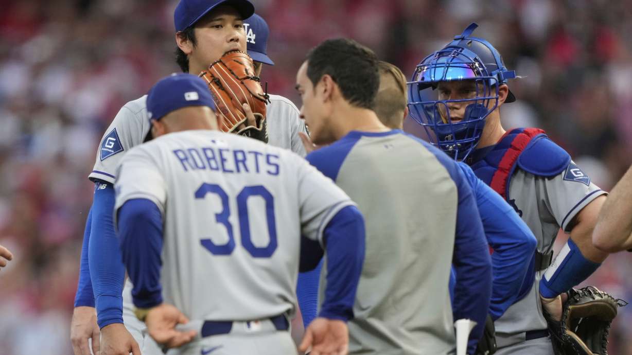 Los Angeles Dodgers' Shohei Ohtani is taken out of the game during the fourth inning of a baseball game against the Cincinnati Reds Wednesday, July 30, 2025, in Cincinnati.