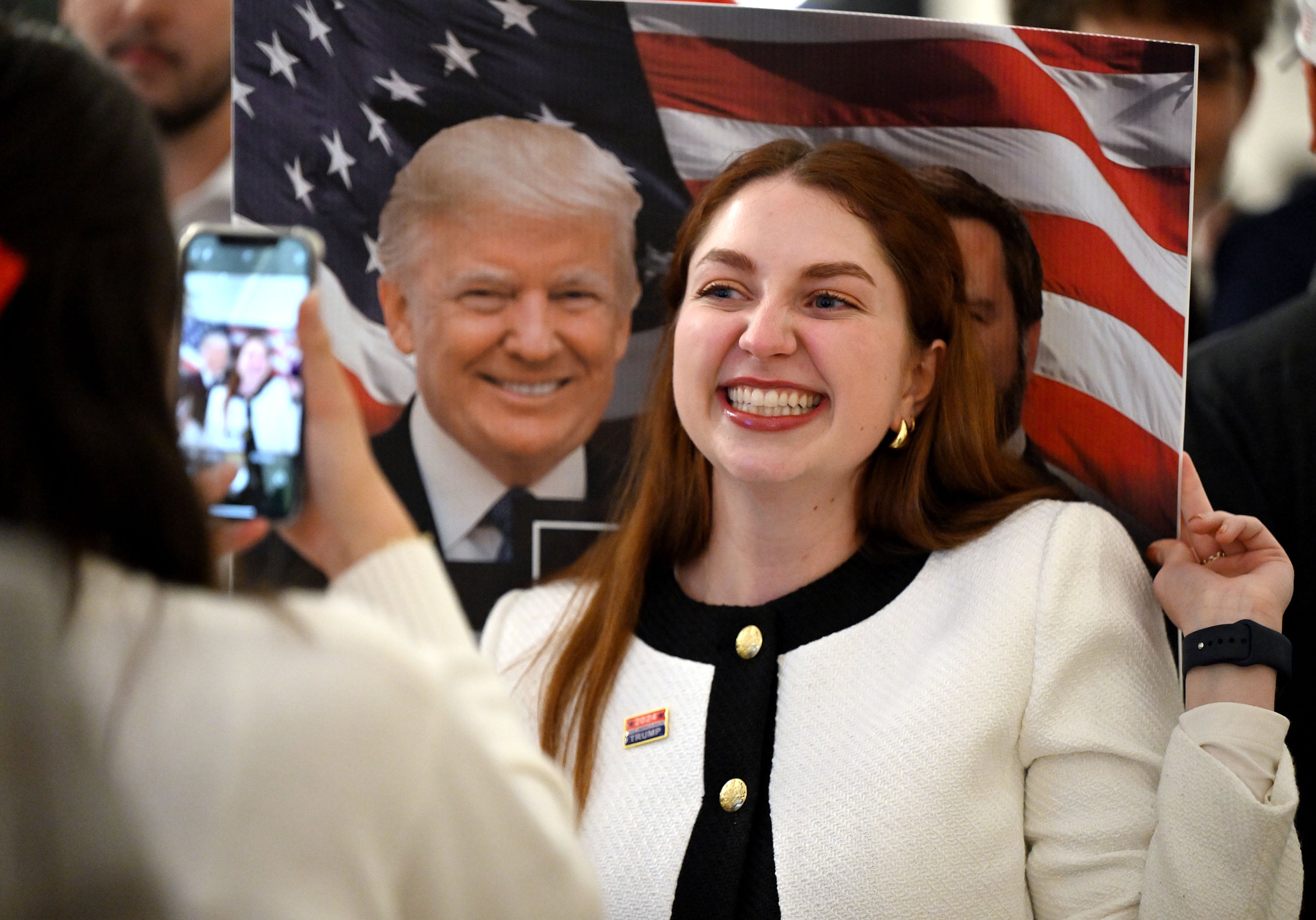 Alexis Morgan poses for a photo while holding a sign featuring President Donald Trump, as Utah GOP at a Draper election party, Nov. 5, 2024. In a new poll, Utahns were asked if they approve or disapprove of Trump's job performance.
