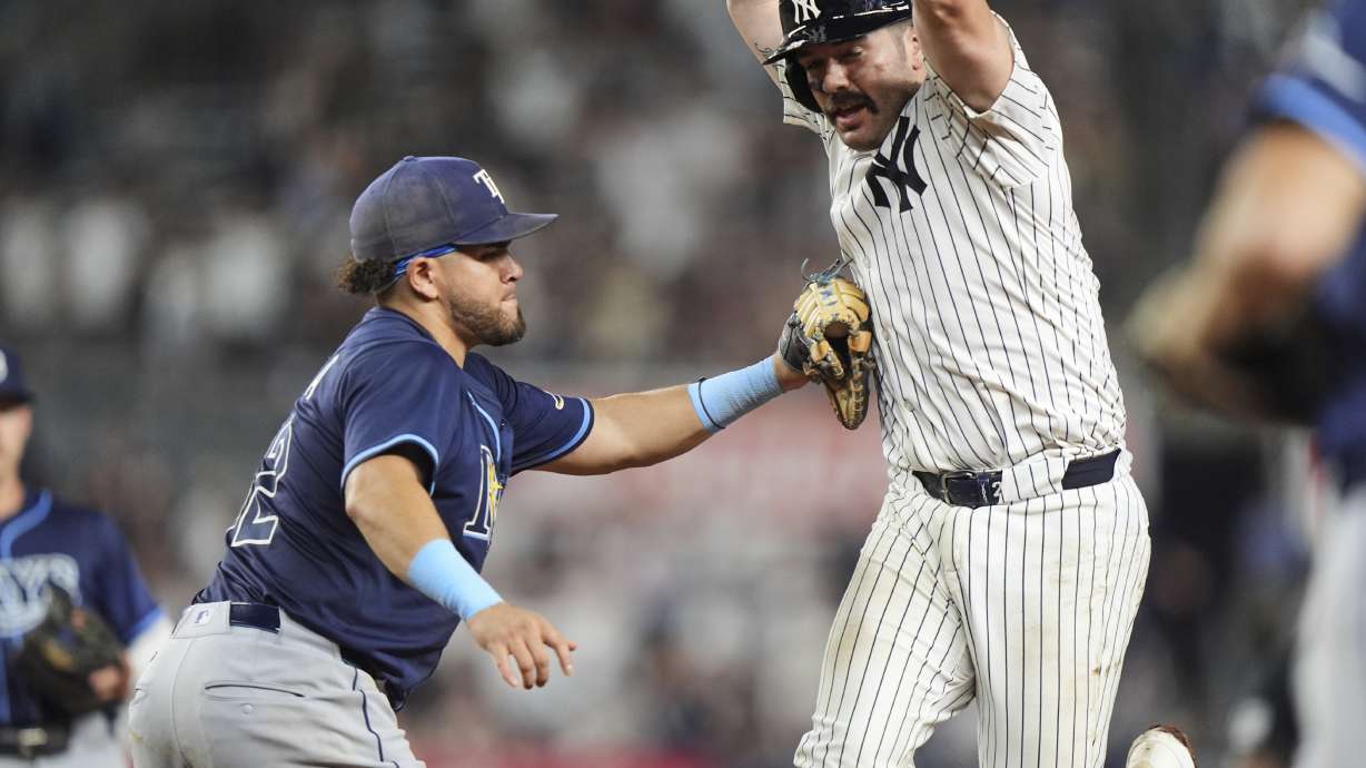 Tampa Bay Rays' Jonathan Aranda tags out New York Yankees' Austin Wells during the ninth inning of a baseball game Wednesday, July 30, 2025, in New York.
