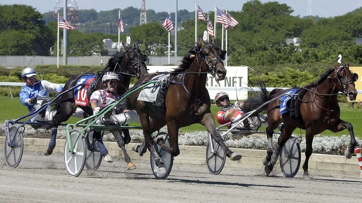 FILE - Glidemaster (8), driven by John Campbell, pulls away from Chocolatier (10), driven by Doug R. Ackerman and Blue Mac Lad (2), driven by George Brennan, to win the Hambletonian harness race Saturday, Aug. 5, 2006 at Meadowlands Racetrack in East Rutherford, N.J.