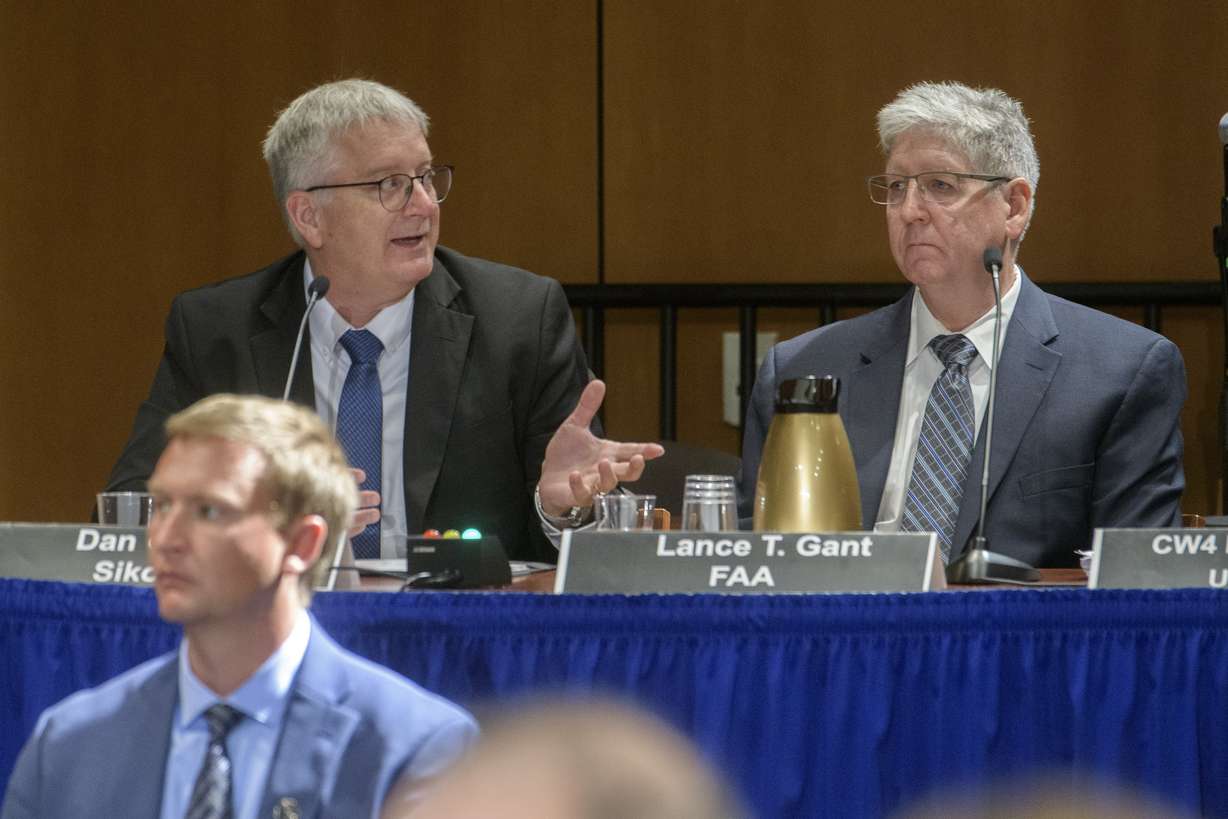 Dan Cooper and Lance Gant respond to questions at the National Transportation and Safety Board, Wednesday, in Washington. The final report on January's fatal midair collision is to be released sometime next year.