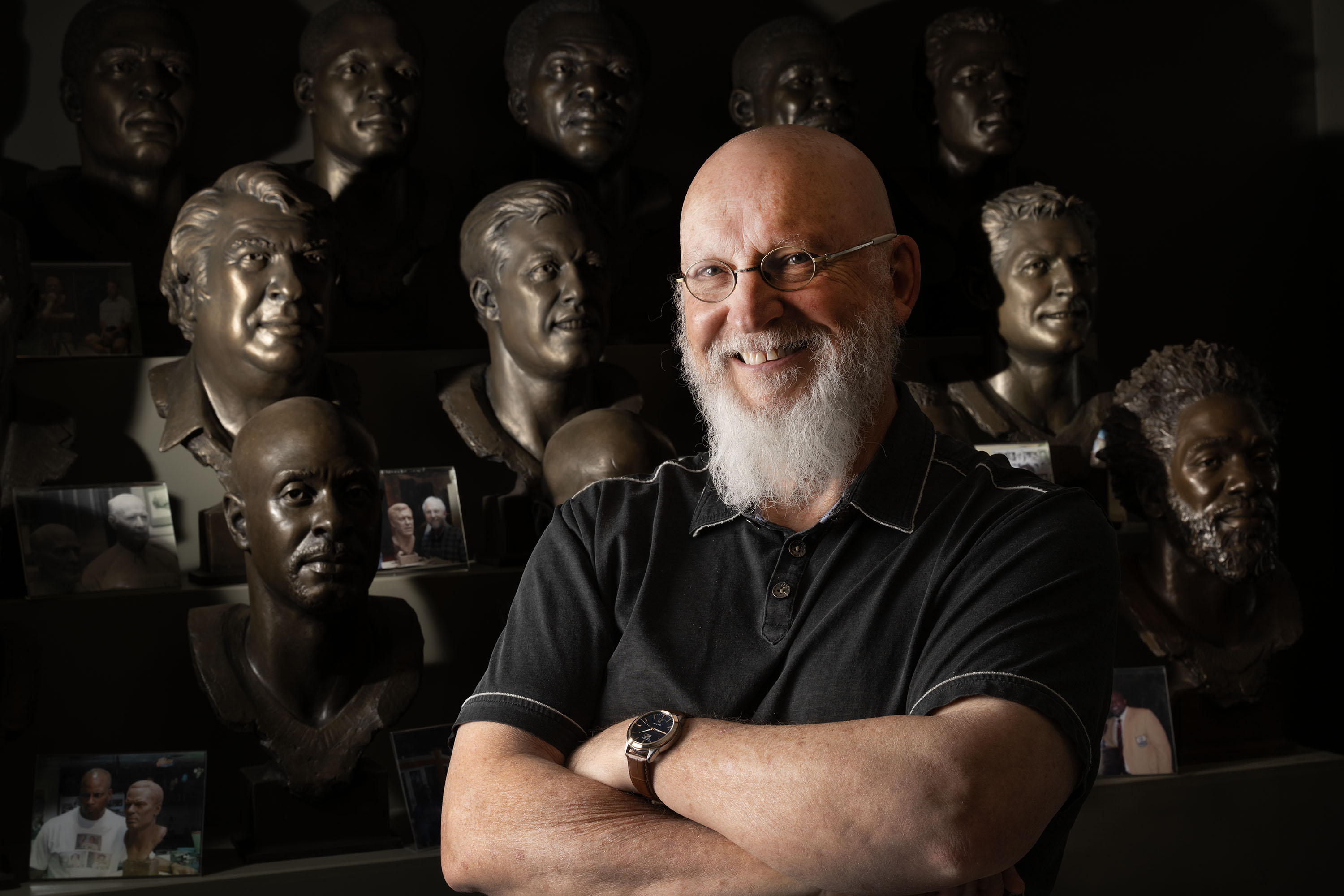 Former BYU-football-player-turned-professional-sculptor Blair Buswell poses near several of his NFL Hall of Fame busts in his studio in Pleasant Grove on Monday.