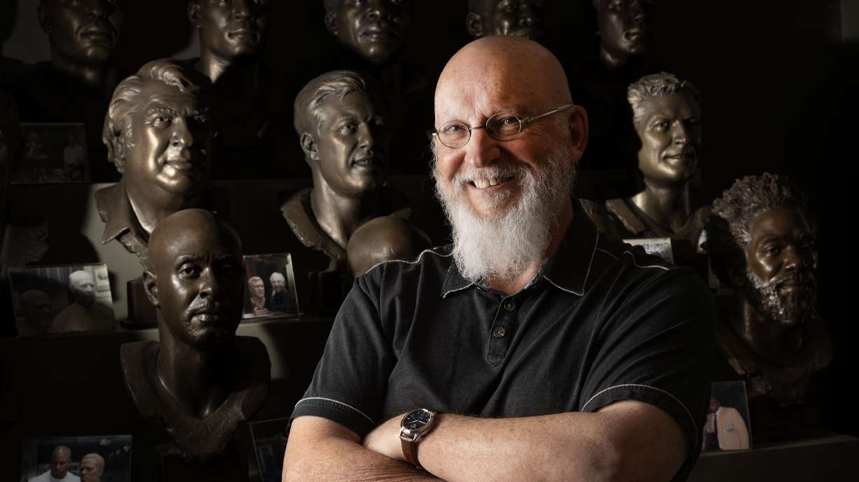 Former BYU-football-player-turned-professional-sculptor Blair Buswell poses near several of his NFL Hall of Fame busts in his studio in Pleasant Grove on Monday.
