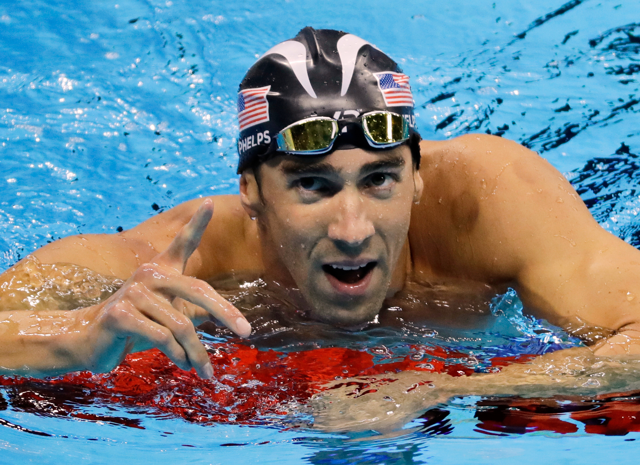 FILE - United States' Michael Phelps reacts after winning the silver medal in the men's 100-meter butterfly final during the swimming competitions at the 2016 Summer Olympics, Friday, Aug. 12, 2016, in Rio de Janeiro, Brazil.