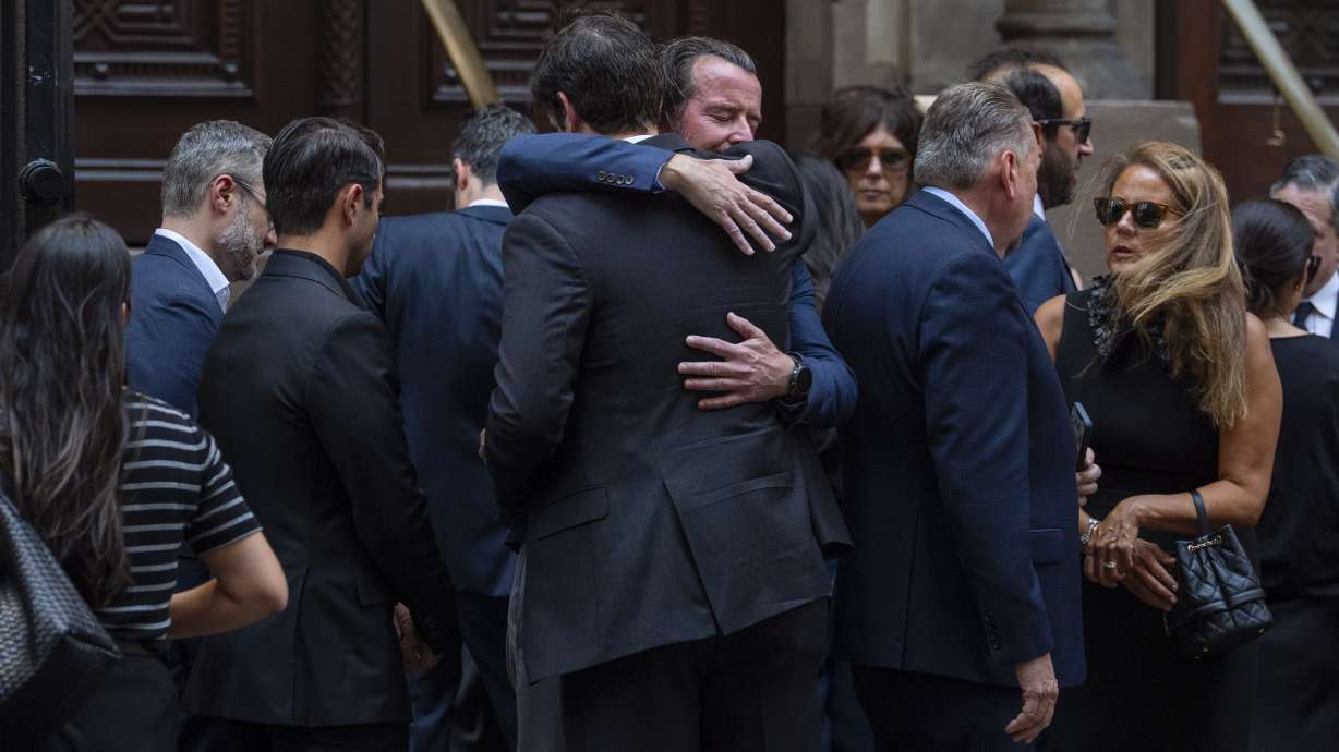 People embrace each other following a funeral of Julia Hyman, associate at Rudin Management Company, one of the victims of Monday's deadly shooting, Wednesday, July 30, 2025, in New York.