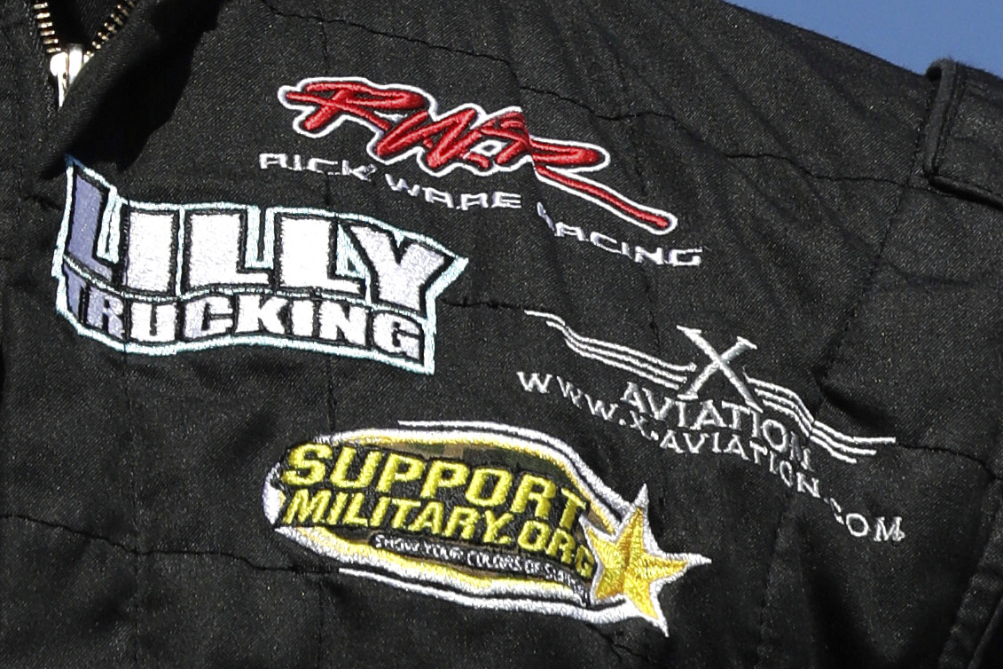 FILE - A Rick Ware Racing patch is displayed on the fire suit of driver Cody Ware prior to the NASCAR Cup Series 300 auto race at New Hampshire Motor Speedway in Loudon, N.H., Sunday, Sept. 24, 2017.