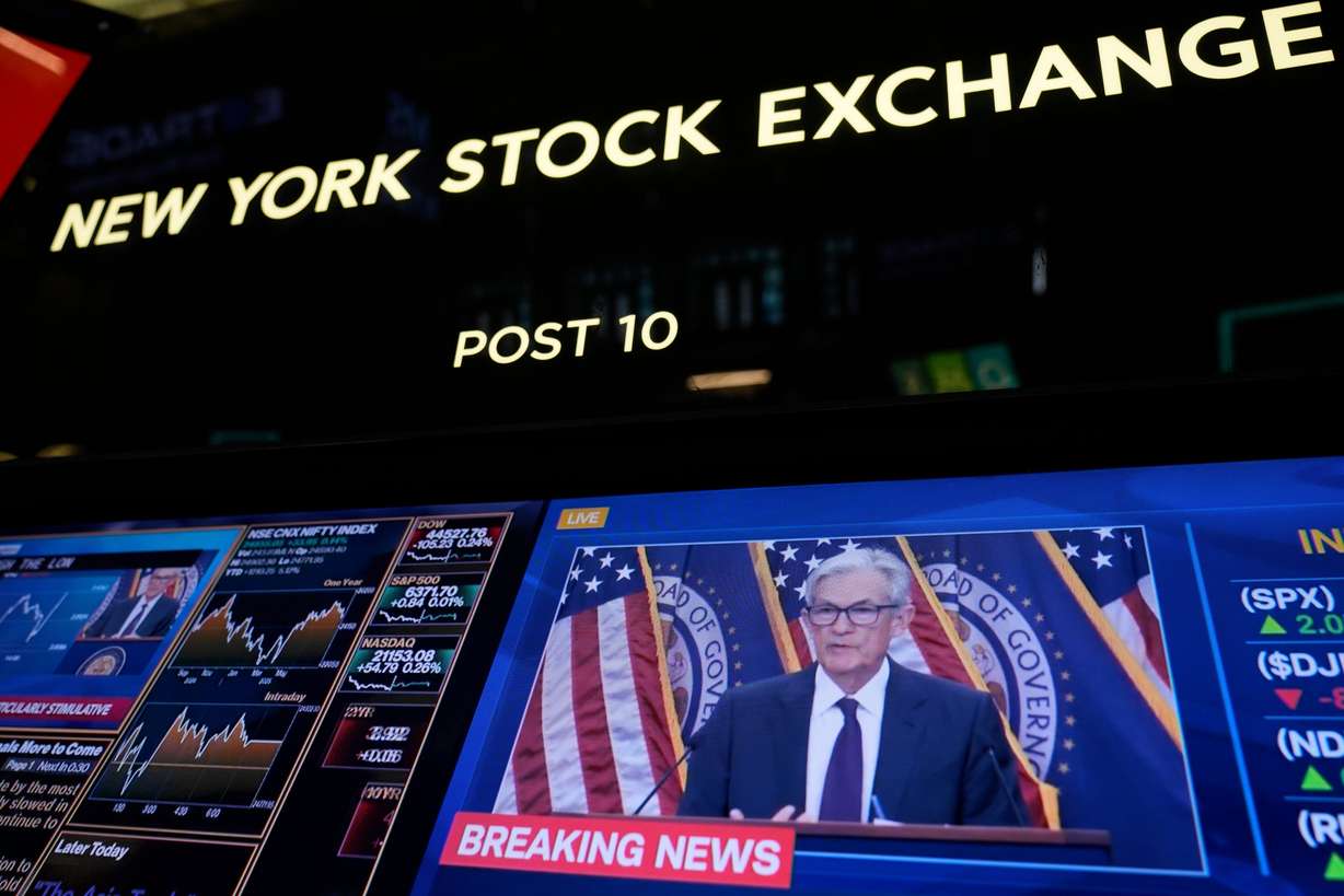 Fed Chairman Jerome Powell speaks at a press conference, shown on TV on the floor at the New York Stock Exchange in New York, Wednesday. Mortgage rates slipped slightly a day after the Fed held interest rates steady.
