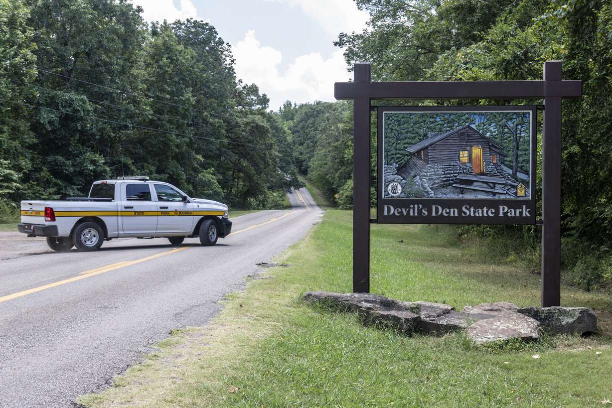 An Arkansas park ranger patrols the south entrance of Devils Den State Park Monday, in West Fork, Ark.