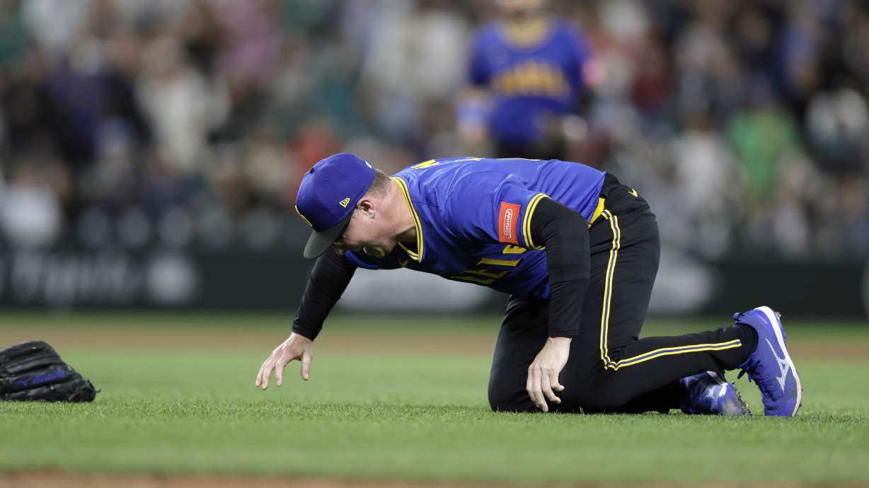 Seattle Mariners pitcher Trent Thornton goes to the ground with an injury during the ninth inning against the Texas Rangers in a baseball game Thursday, July 31, 2025, in Seattle.