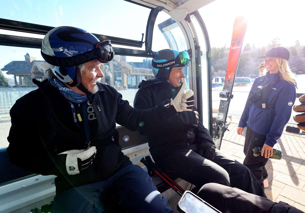 Tom Hart and Jeff Toone talk to a lift operator from the Needles gondola at Snowbasin Resort in Weber County on April 10. Hart says skiing never gets old.
