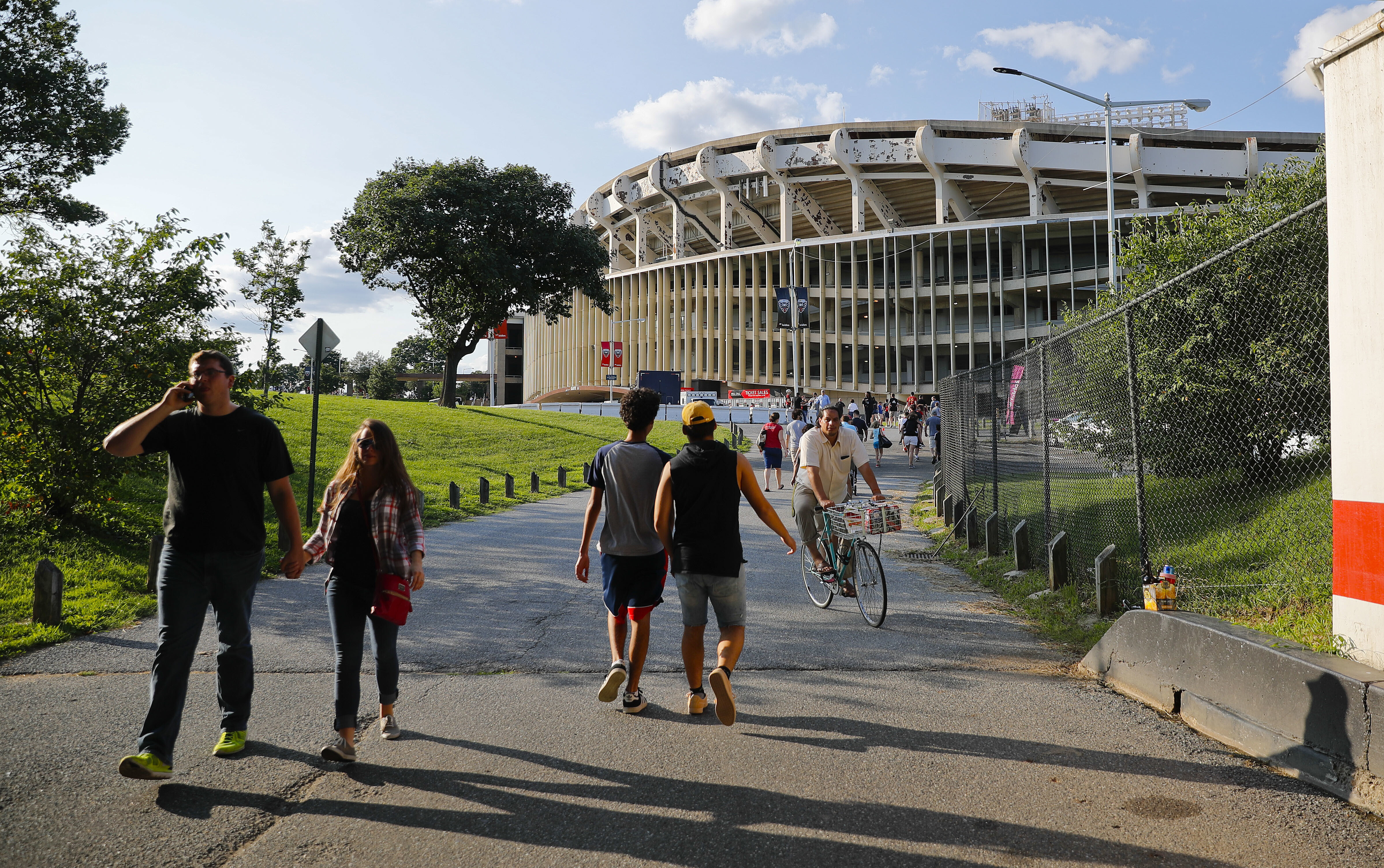 FILE - People make their way to RFK Stadium in Washington before the start of an MLS soccer match between D.C. United and Toronto FC, Saturday, Aug. 5, 2017. D.C. 