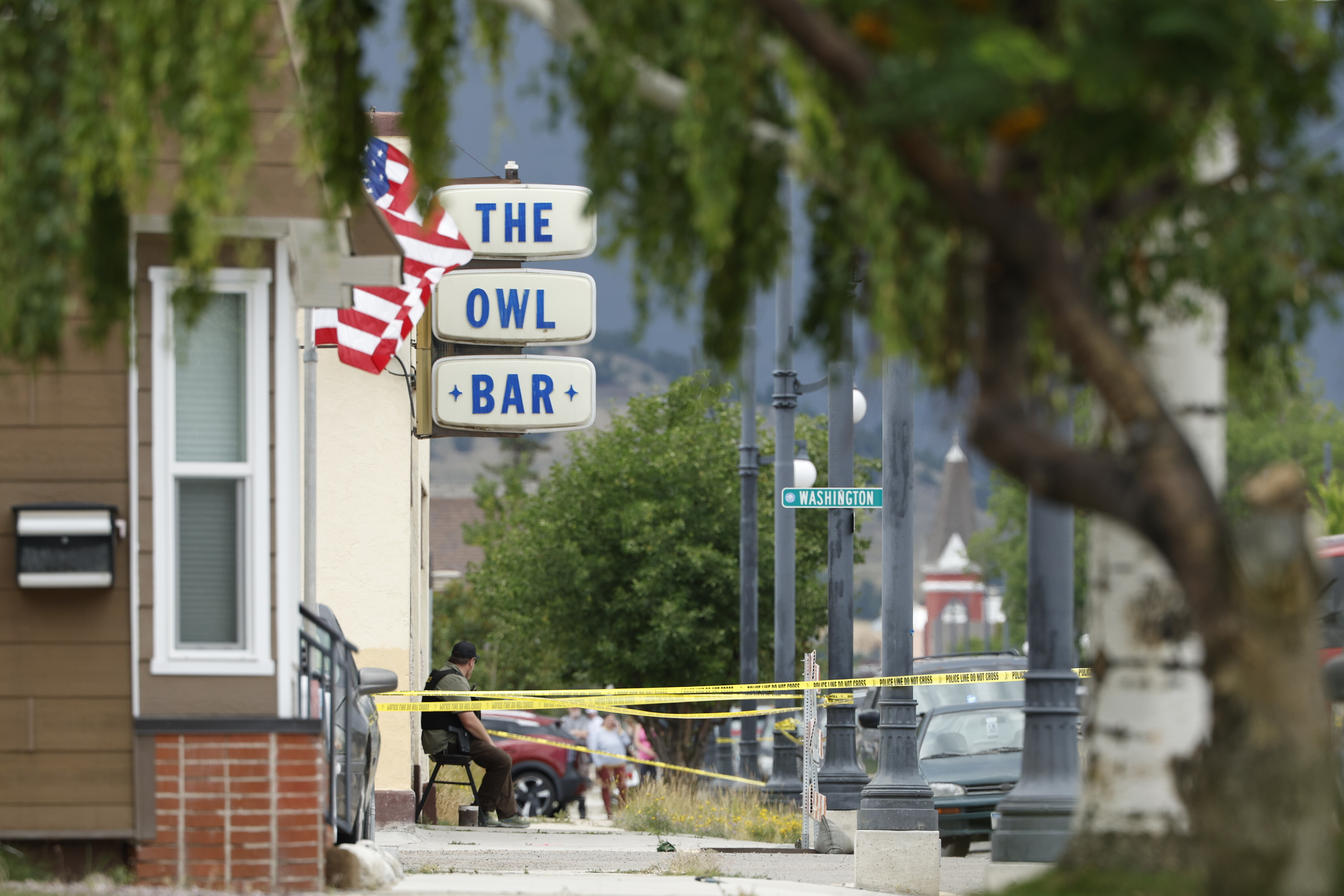 Police tape surrounds The Owl Bar in Anaconda, Mont., on Friday, following a fatal shooting. Four people were killed in the shooting, and police are hunting for a military veteran believed to be the suspect.