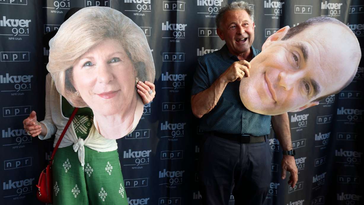 Wendy Kohn and Paul Kohn pose for photos with cutouts of NPR's Nina Totenberg and "Wait Wait... Don’t Tell Me!" host Peter Sagal before watching a recording of the NPR news game show at Abravanel Hall in Salt Lake City on Thursday.