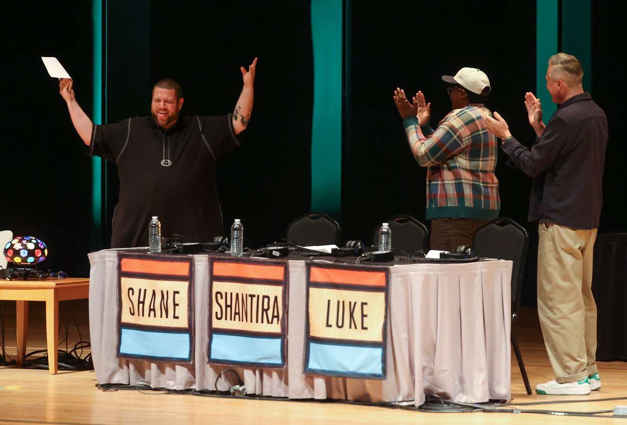 "Wait Wait... Don’t Tell Me!" panelists Shane O’Neill, Shantira Jackson and Luke Burbank are welcomed onto the stage for a recording of the NPR news game show at Abravanel Hall in Salt Lake City on Thursday.