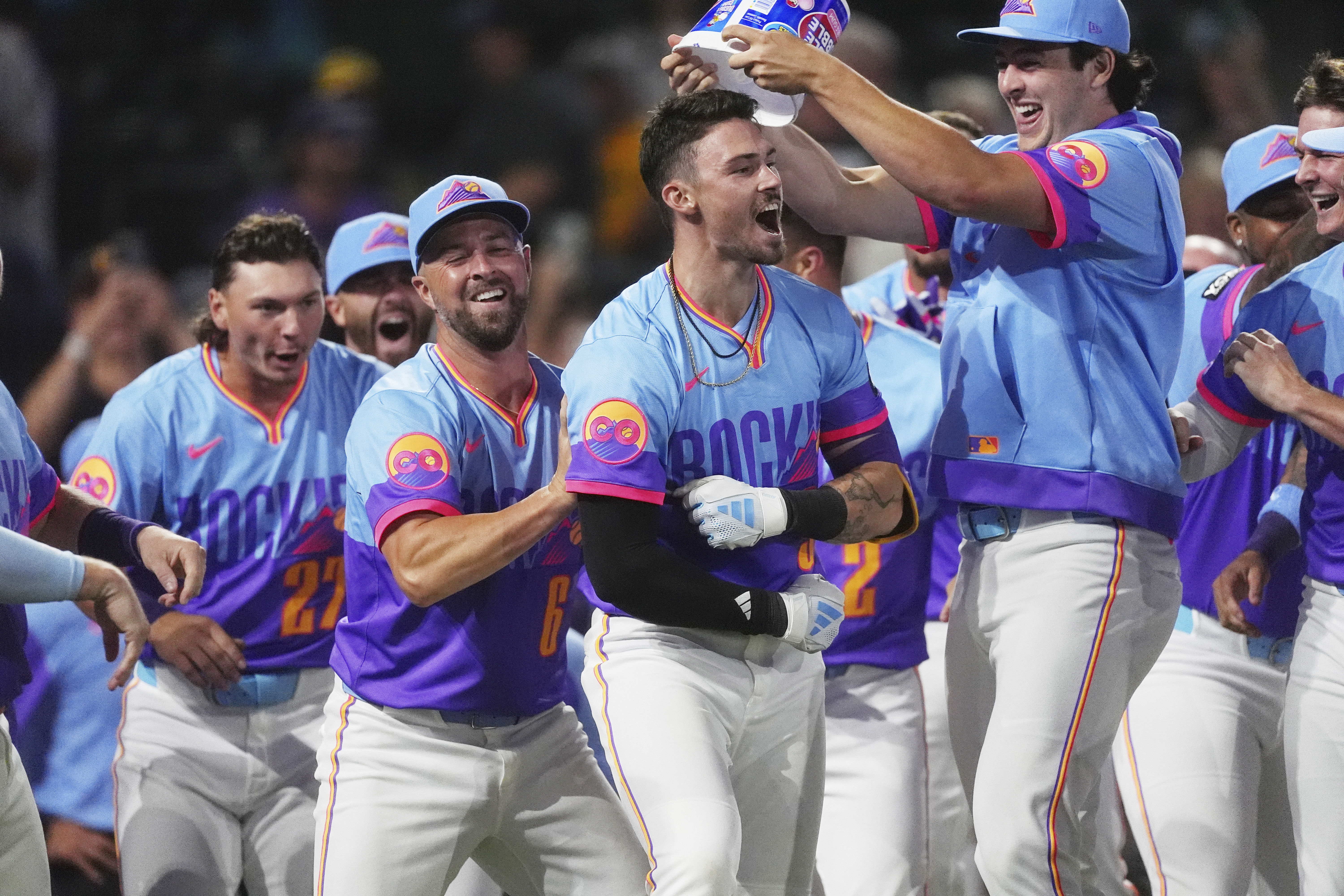 Colorado Rockies' Brenton Doyle, third from left, celebrates after hitting a two-run, walkoff home run with teammates, from left, Jordan Beck, Kyle Farmer and Michael Toglia in the ninth inning of a baseball game against the Pittsburgh Pirates Friday, Aug. 1, 2025, in Denver.