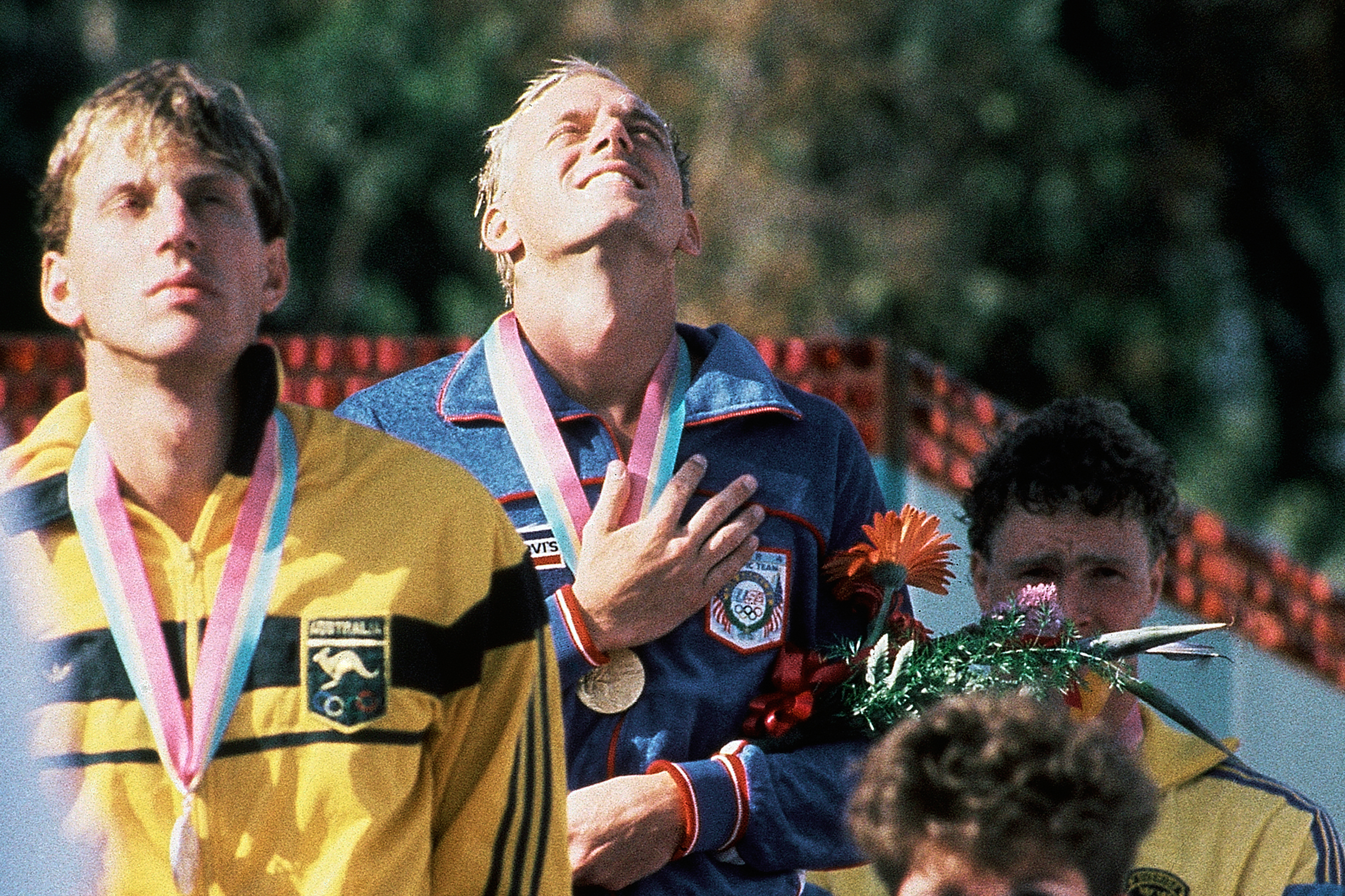 FILE - America's Rowdy Gaines, gold medal, Mark Stockwell of Australia, silver medal, and Per Johansson of Sweden, bronze medal, on the podium after the Men's 100 Meter Freestyle Swimming Event at the Summer Olympic Games in Los Angeles, on July 31, 1984.