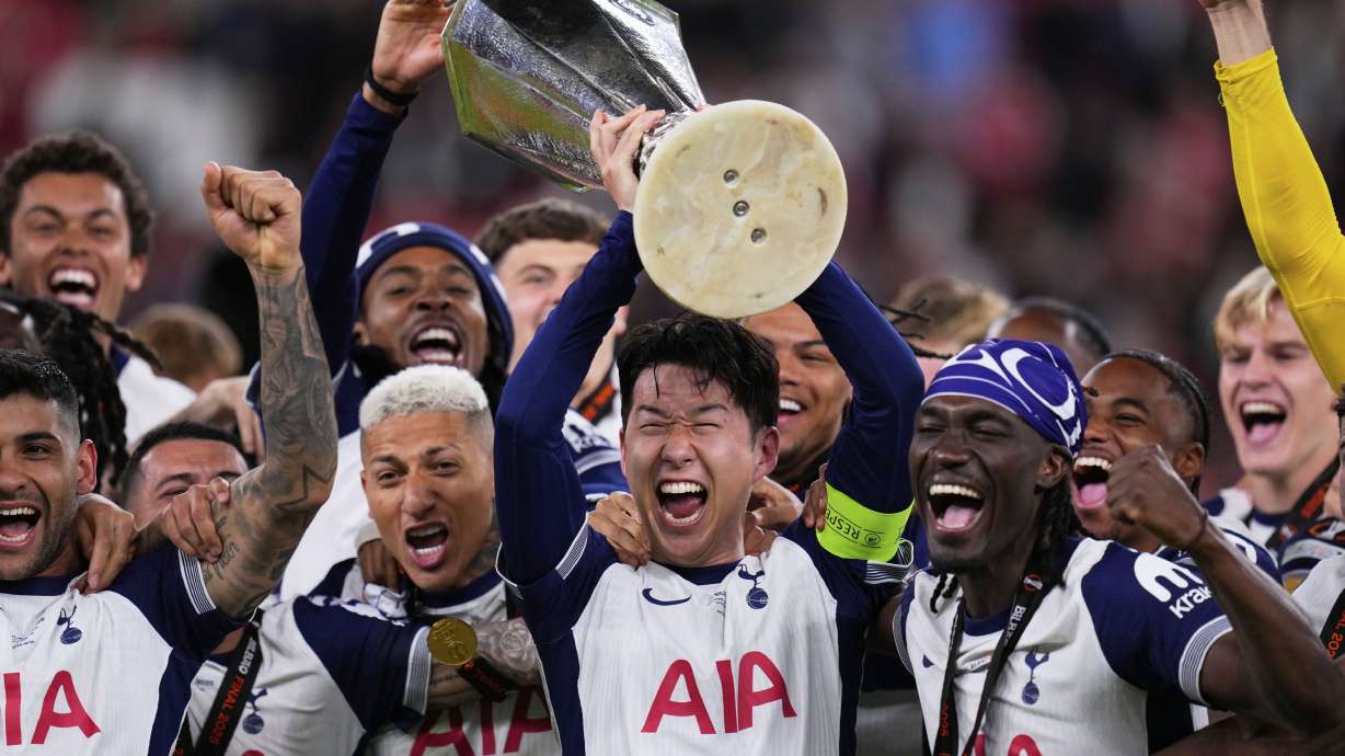 FILE - Tottenham's Son Heung-min holds the trophy aloft as he celebrates with teammates after winning the Europa League final soccer match against Manchester United at the San Mames Stadium in Bilbao, Spain, on May 21, 2025.