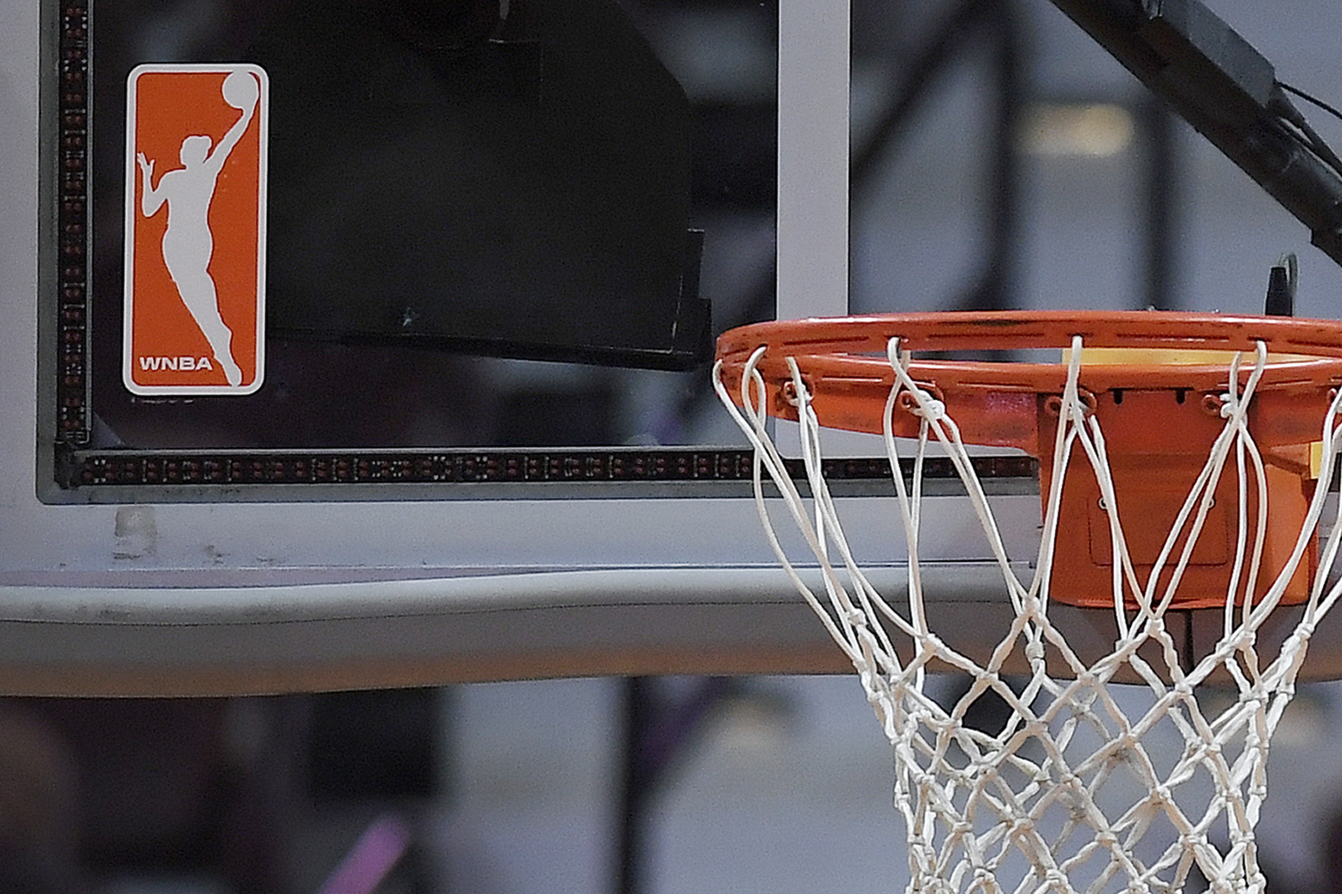 FILE - The WNBA logo is seen near a hoop before an WNBA basketball game at Mohegan Sun Arena, Tuesday, May 14, 2019, in Uncasville, Conn.