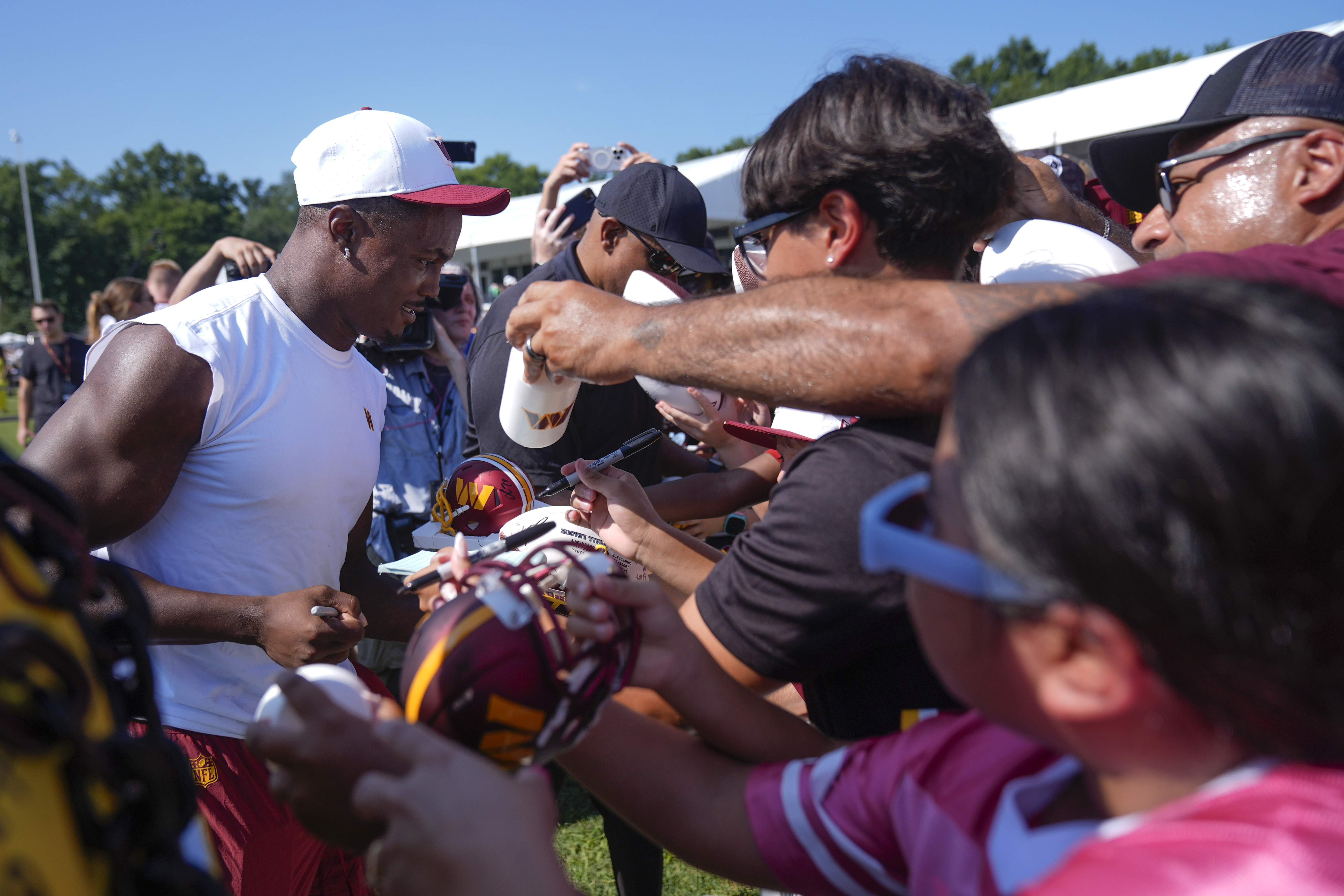 Washington Commanders wide receiver Terry McLaurin signs autographs for fans after a practice at the team's NFL football training camp, Sunday, July 27, 2025, in Ashburn, Va.