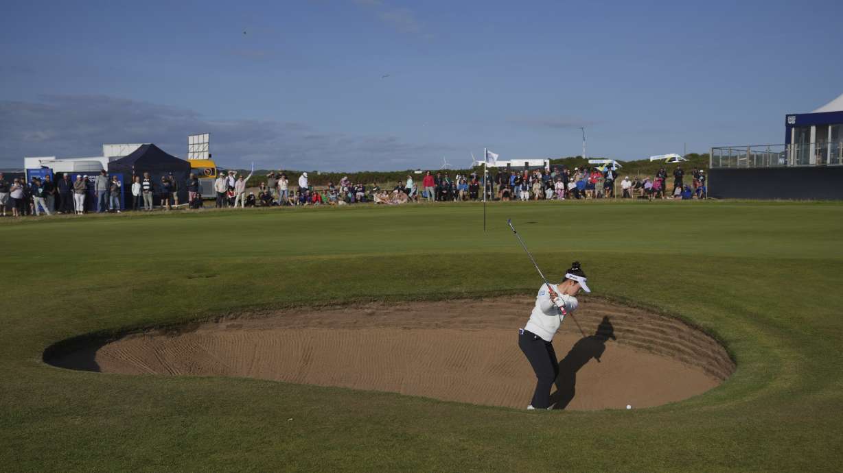 Miyu Yamashita of Japan chips out of a bunker on the 17th green during the third round of the Women's British Open golf championship, at Royal Porthcawl Golf Club in Porthcawl, Wales, Saturday, Aug. 2, 2025.