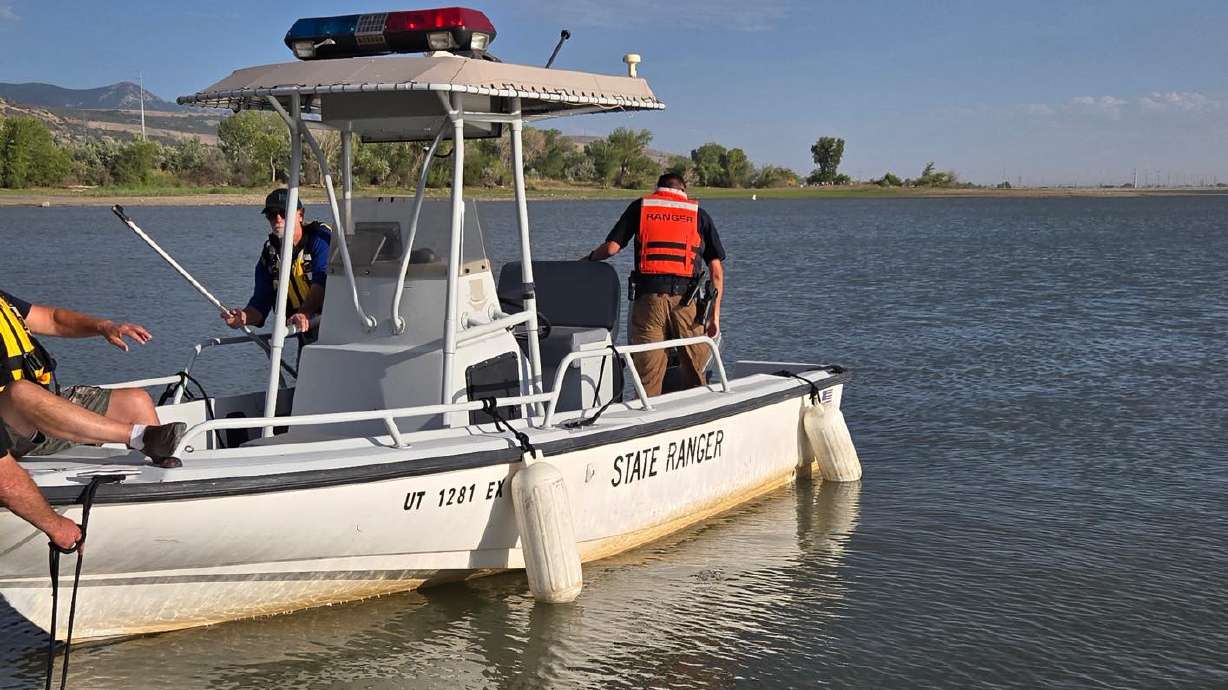 Rescue crews search for a man who fell off a raft at Willard Bay State Park Saturday. His body was recovered late Saturday.
