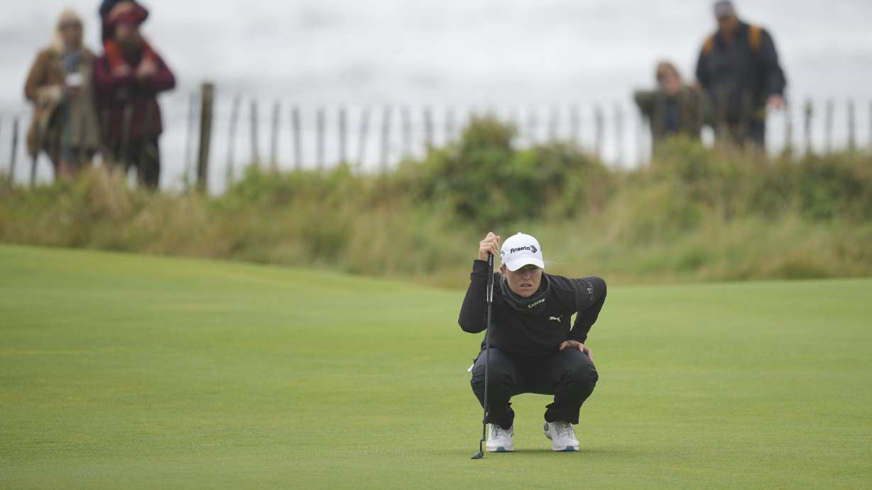 Mimi Rhodes of England lines up a putt on the 1st green during the final round of the Women's British Open golf championship, at Royal Porthcawl Golf Club in Porthcawl, Wales, Sunday, Aug. 3, 2025.