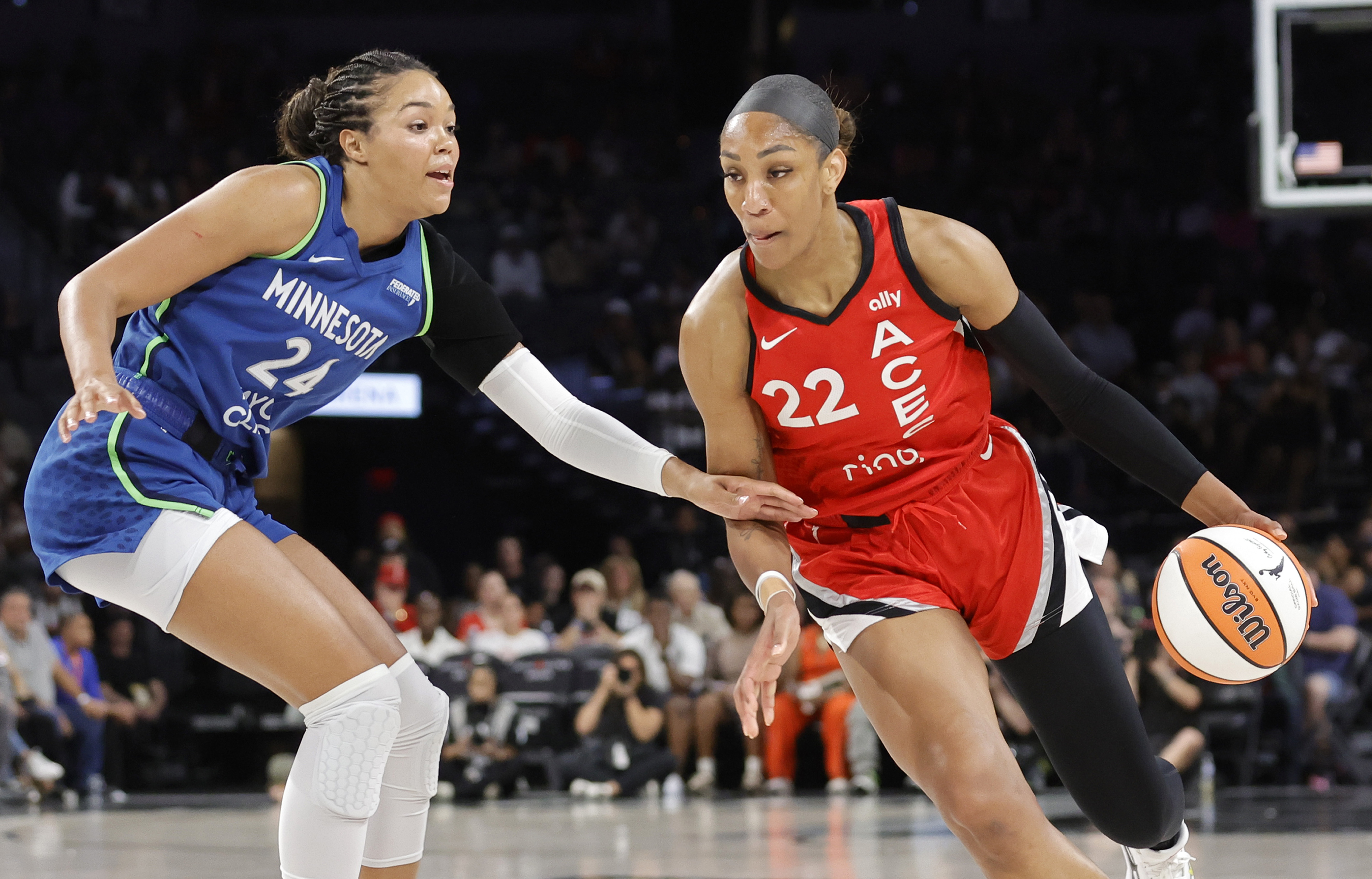 Las Vegas Aces center A'ja Wilson (22) drives against Minnesota Lynx forward Napheesa Collier (24) during the first half of a WNBA basketball game Saturday, Aug. 2, 2025, in Las Vegas.