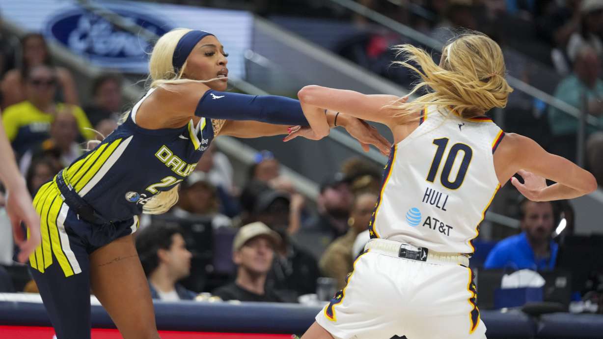 Dallas Wings guard DiJonai Carrington, left, pushes on Indiana Fever guard Lexie Hull (10) during the second half of a WNBA basketball game Friday, Aug. 1, 2025, in Dallas.