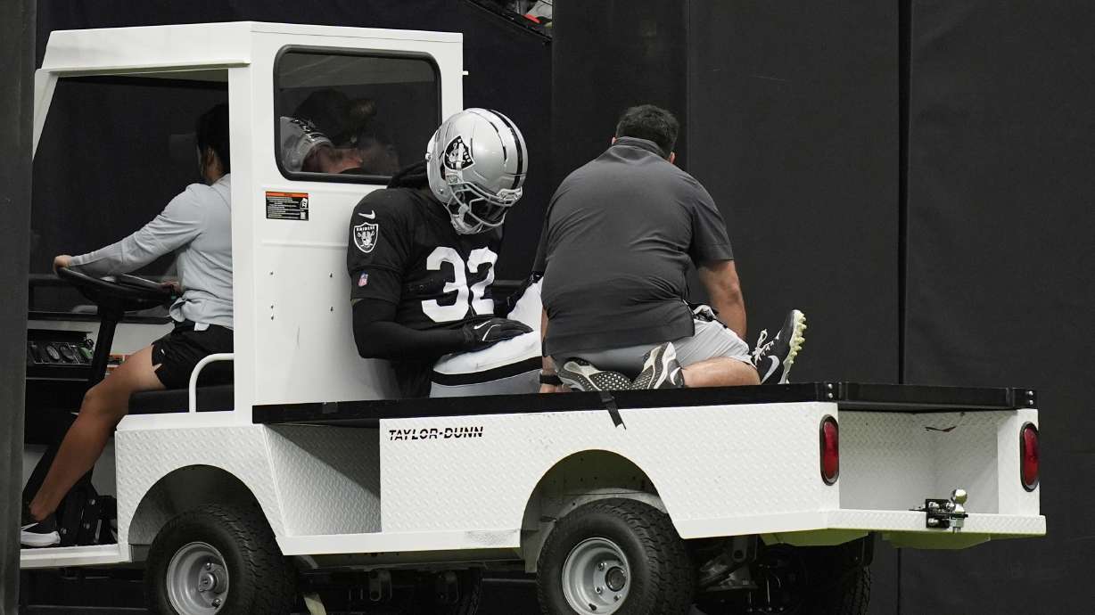Las Vegas Raiders cornerback Lonnie Johnson Jr. (32) is carted off the field at the team's NFL football training camp Saturday, Aug. 2, 2025, in Las Vegas.