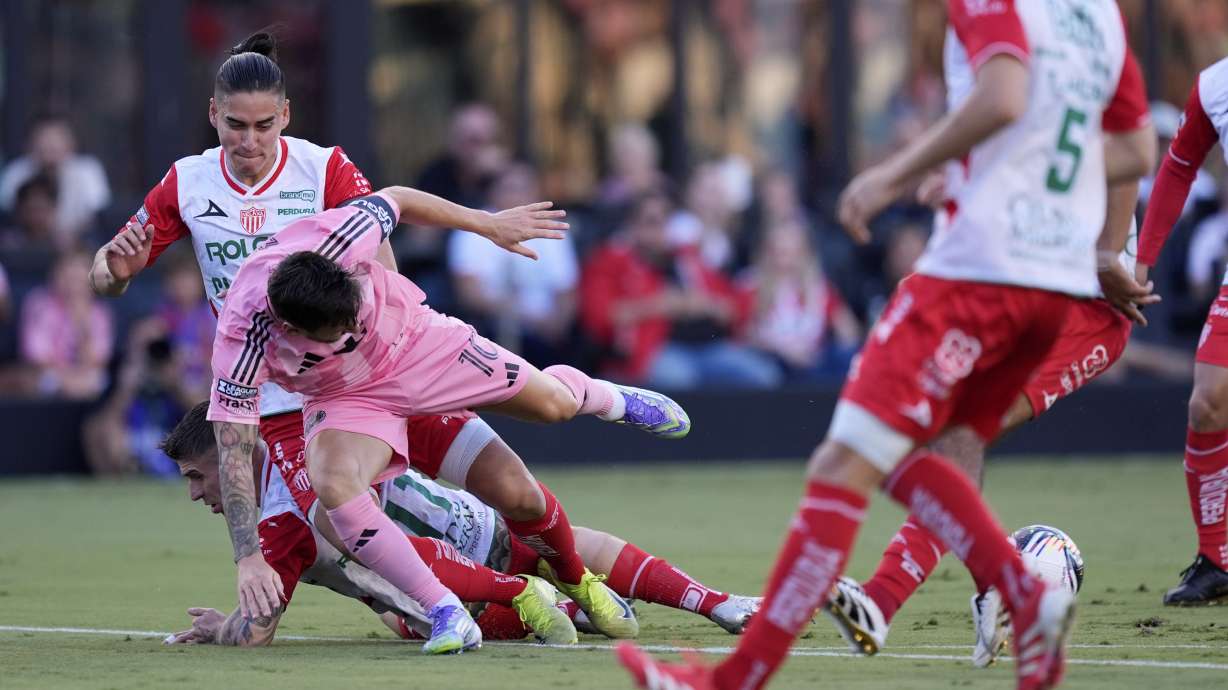 Inter Miami forward Lionel Messi (10) takes a tumble in a clash with Necaxa defenders Alexis Pena, top, and Cristian Calderon, bottom, during the first half of a Leagues Cup soccer match, Saturday, Aug. 2, 2025, in Fort Lauderdale, Fla.