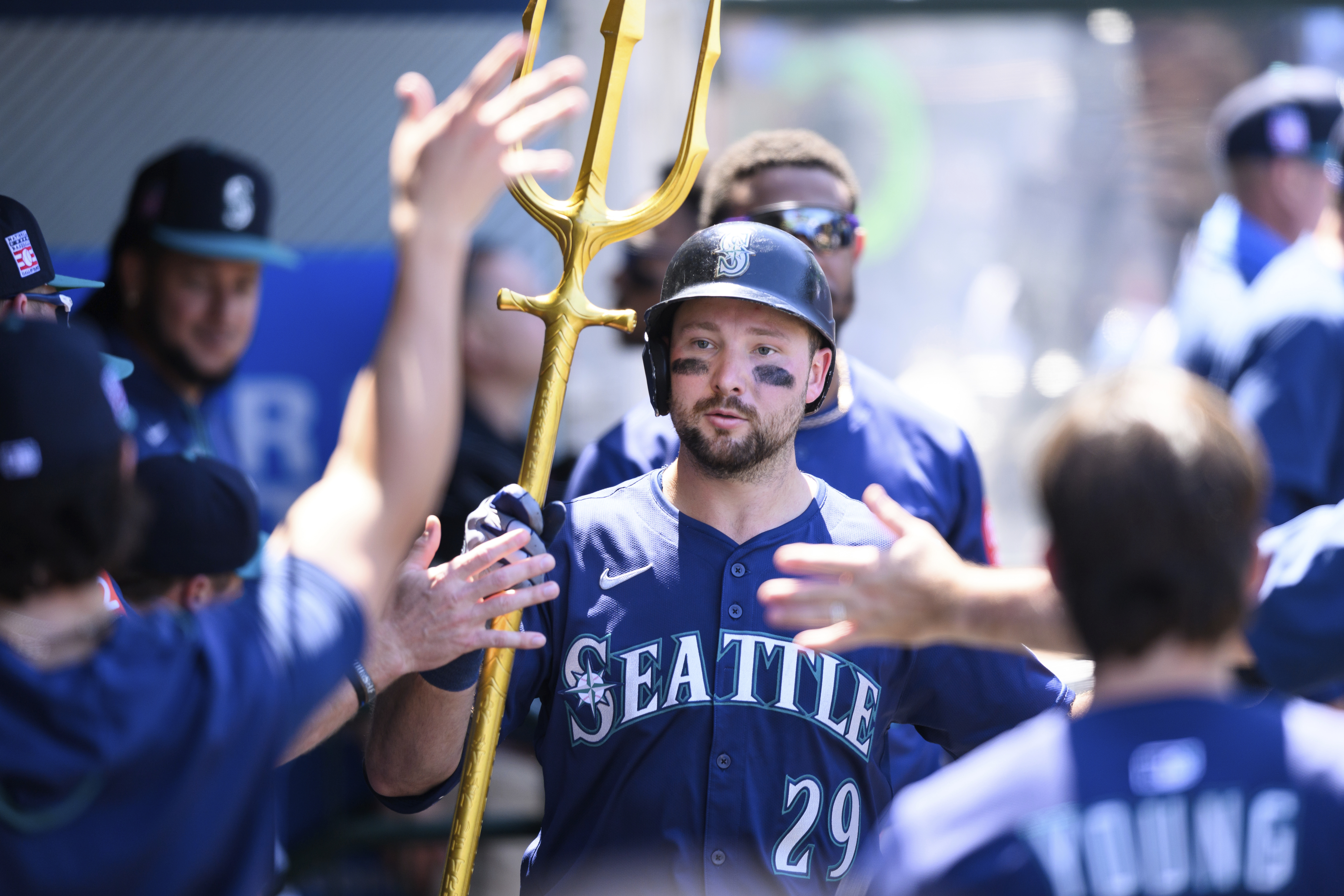 Seattle Mariners' Cal Raleigh is greeted by teammates after hitting a home run during the seventh inning of a baseball game against the Los Angeles Angels Sunday, July 27, 2025, in Anaheim, Calif.