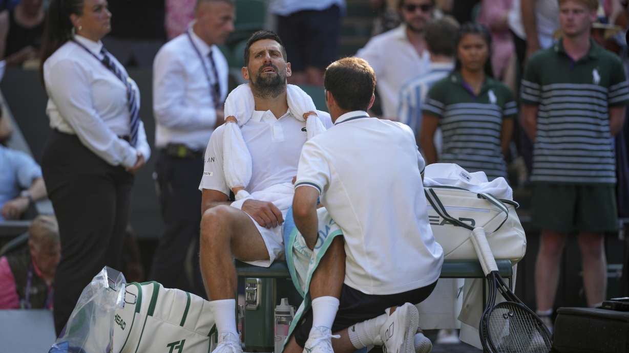 Serbia's Novak Djokovic gets treatment during a medical timeout break against Italy's Jannik Sinner in a men's singles semifinal at the Wimbledon Tennis Championships in London, Friday, July 11, 2025.