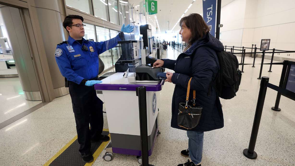 TSA transportation security officer Angel Teran uses a credential authorization technology unit to check Michele Mogilski’s ID at the Salt Lake City International Airport in Salt Lake City, March 9, 2023.