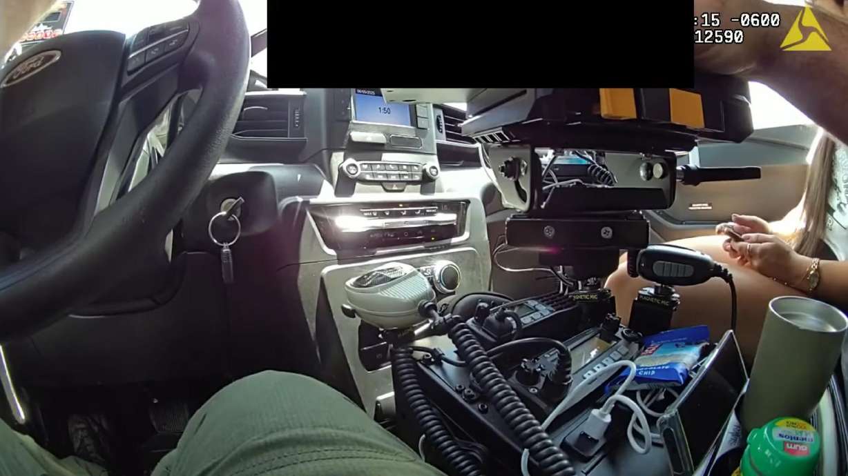 The image from body camera video shows Caroline Dias Goncalves, right, and Mesa County sheriff's deputy Alexander Zwinck inside Zwinck's patrol vehicle during a June 5 traffic stop in Mesa County, Colorado.