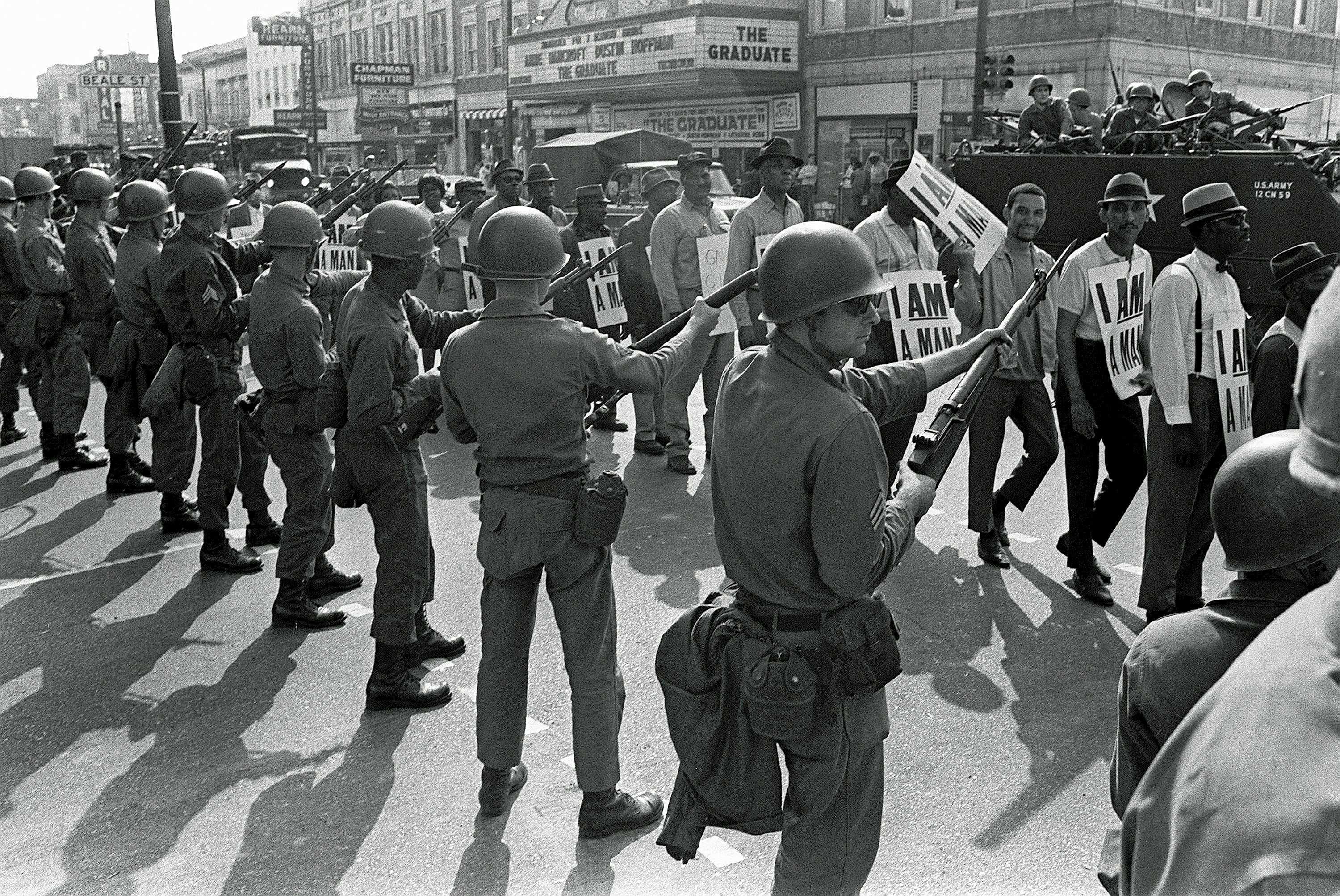 In this March 29, 1968, file photo, striking sanitation workers march past Tennessee National Guard troops with bayonets during a 20-block march to City Hall, one day after a similar march erupted in violence, leaving one person dead and several injured, in Memphis, Tenn.