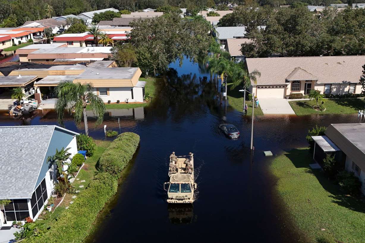 A truck from the Florida National Guard goes out to help residents trapped in their homes as waters rise after Hurricane Milton caused the Anclote River to flood, Oct. 12, 2024, in New Port Richey, Fla.