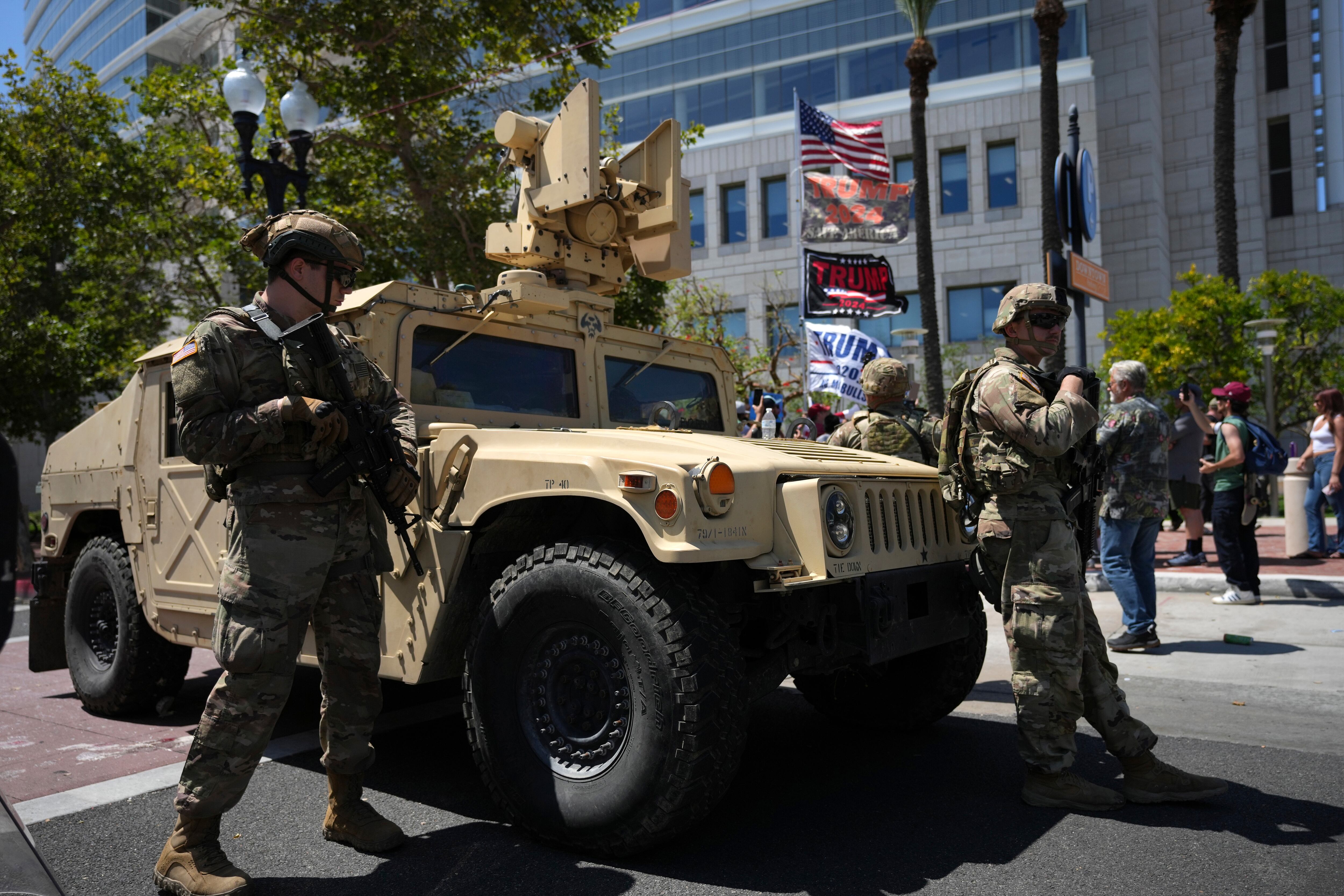 California National Guard stand guard along a street near protesters and Trump supporters in Santa Ana, Calif. on Tuesday, June 10, 2025.