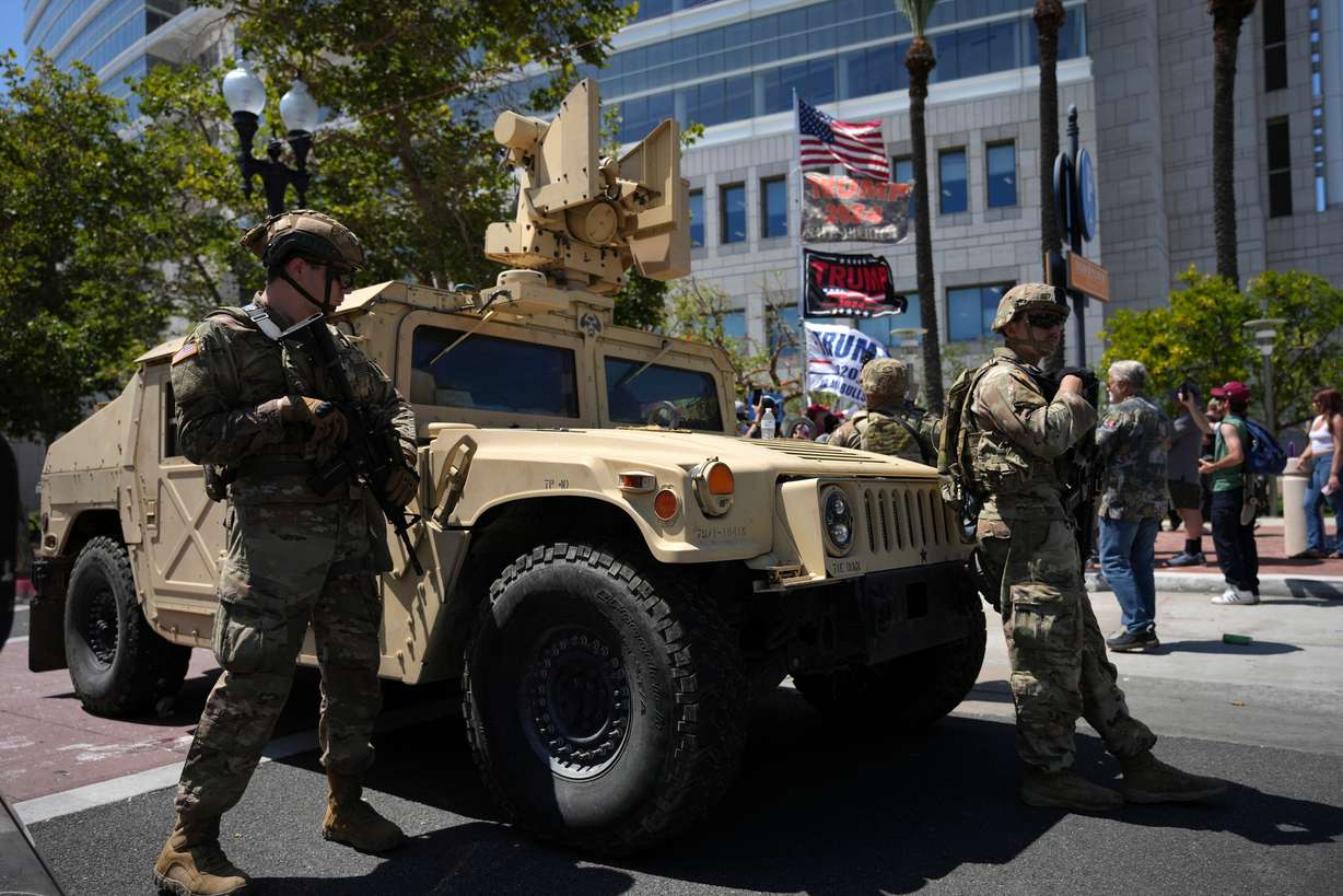 California National Guard stand guard along a street near protesters and Trump supporters in Santa Ana, Calif. on Tuesday, June 10, 2025.