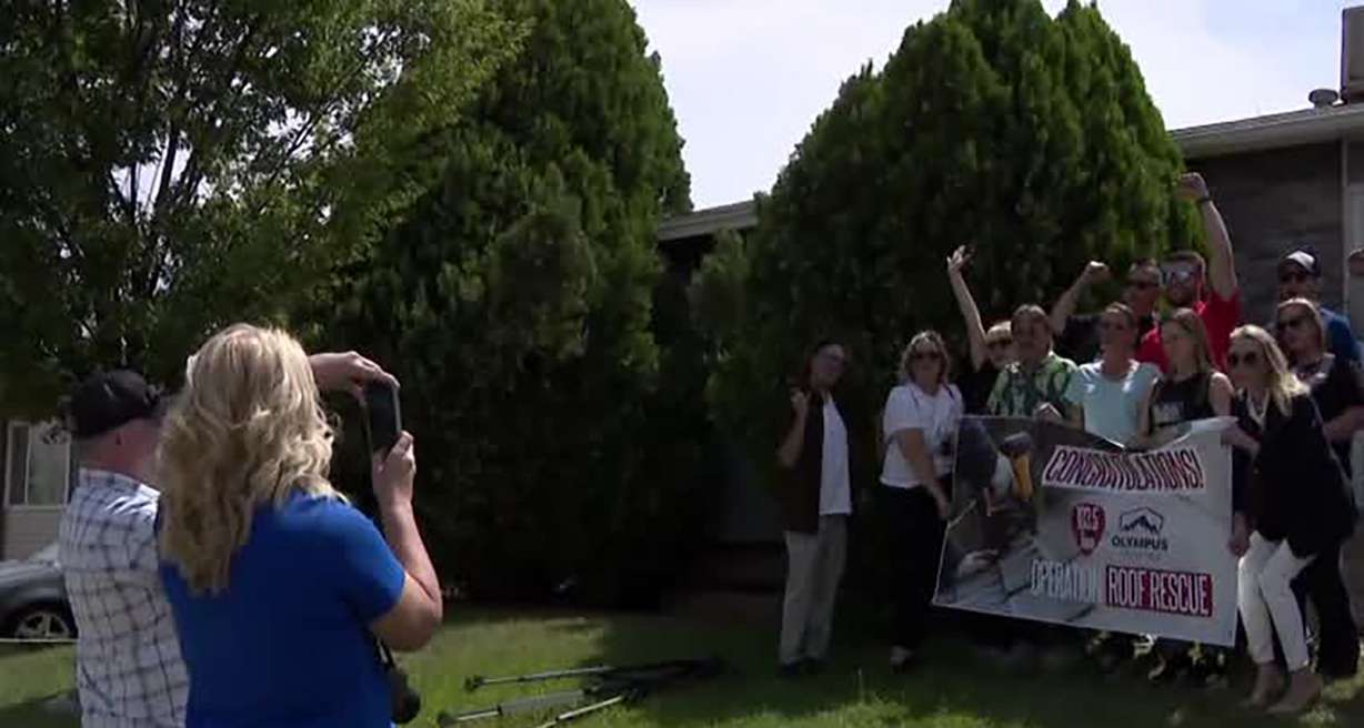 Star Weber, a single mother of four who lives with her father — a disabled military veteran — and friends celebrate upon learning they would receive a new roof for their home from Operation Roof Rescue, in Kearns Monday.